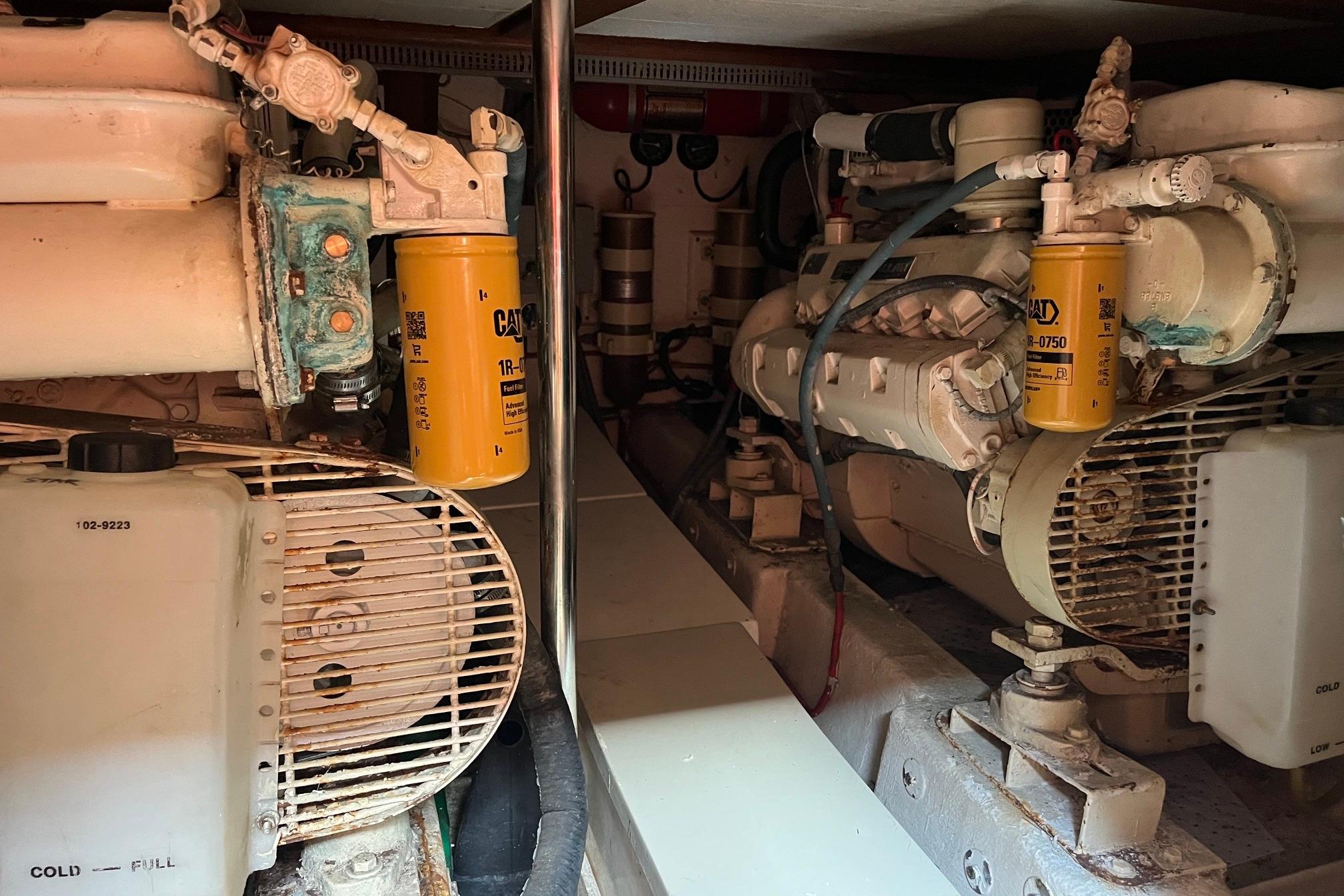 Engine room of 1989 Ocean Alexander 440 Sundeck CPMY with visible machinery and filters.