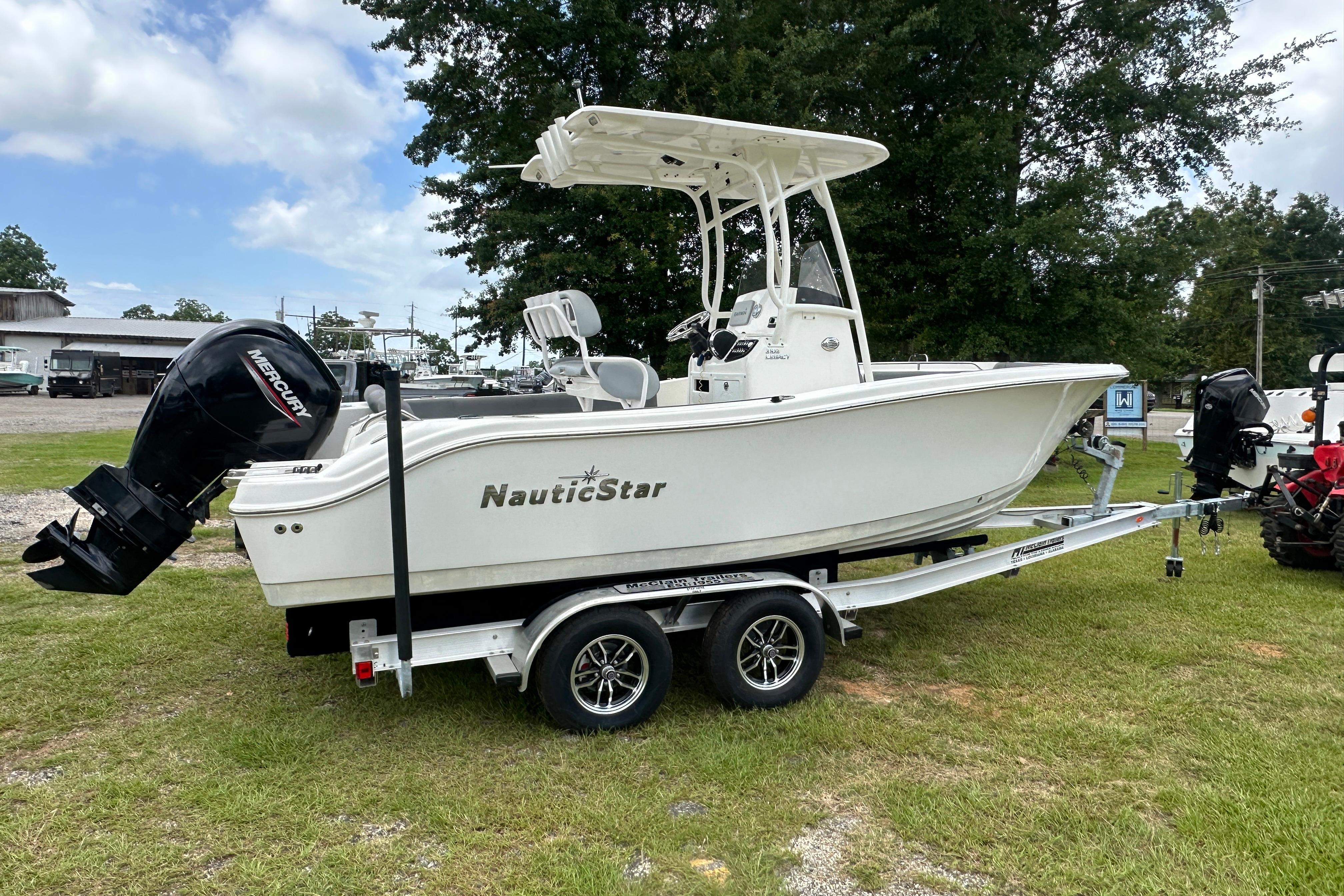 2023 NauticStar 2102 Legacy boat on trailer, featuring Mercury outboard motor.