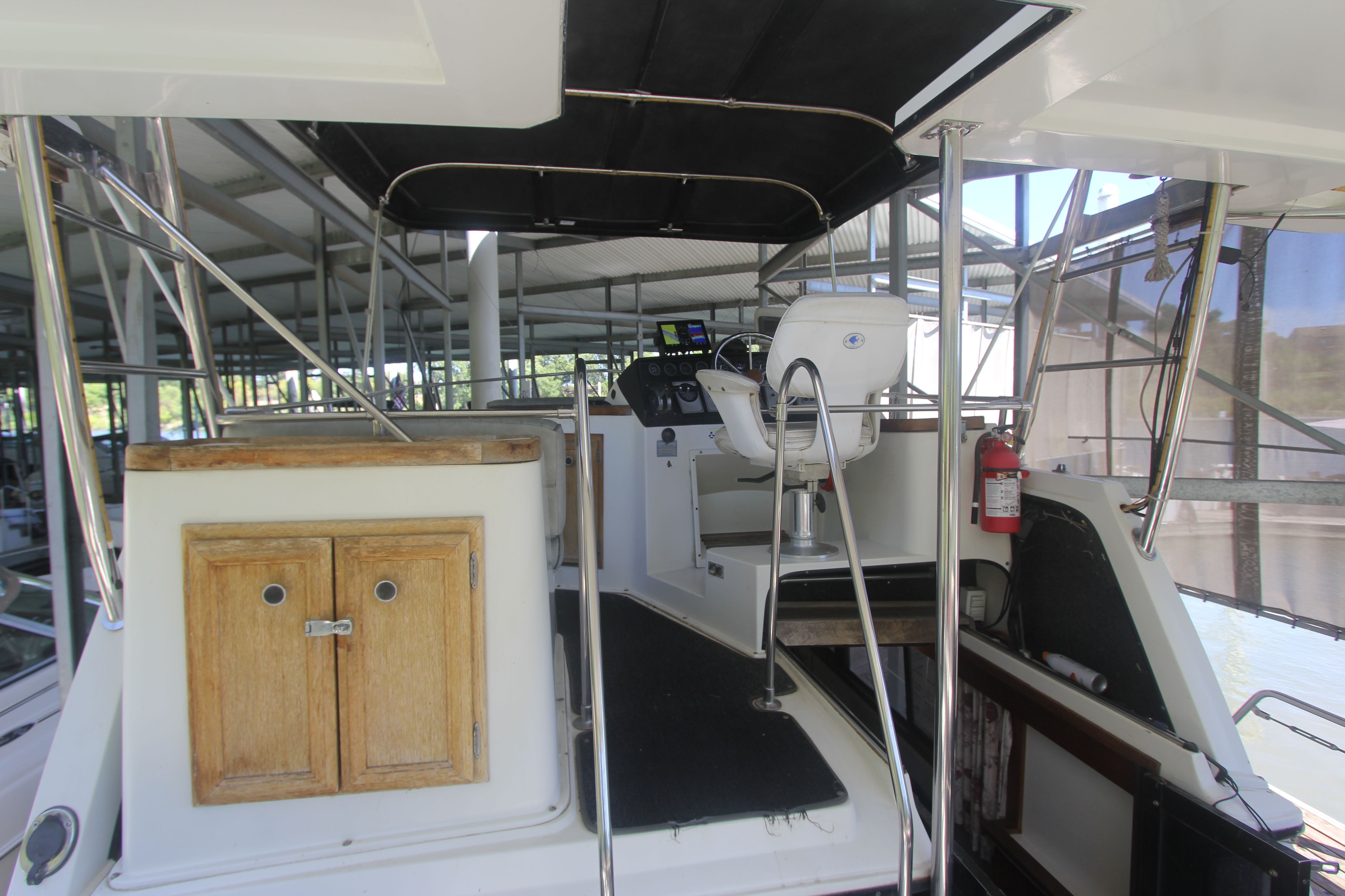 The image shows the cockpit of a 1988 Carver 3607 Aft Cabin Motor Yacht with helm and seating.
