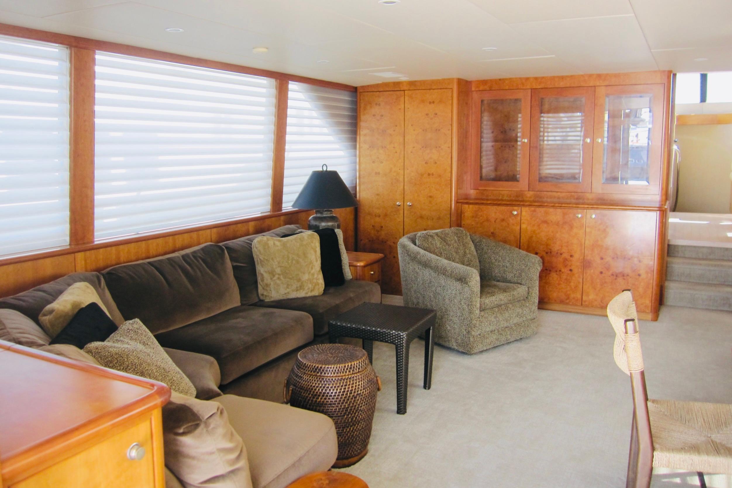 Luxurious interior of 1999 Delta Marine Raised Pilothouse Motoryacht with plush seating and wood cabinetry.