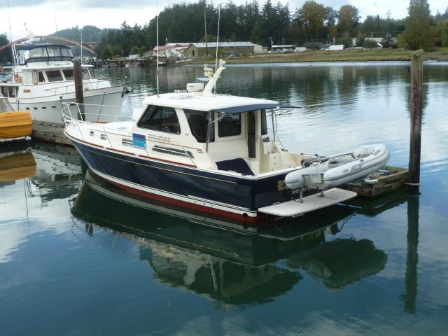 2006 Sabre 38 Express boat docked in a serene marina setting.