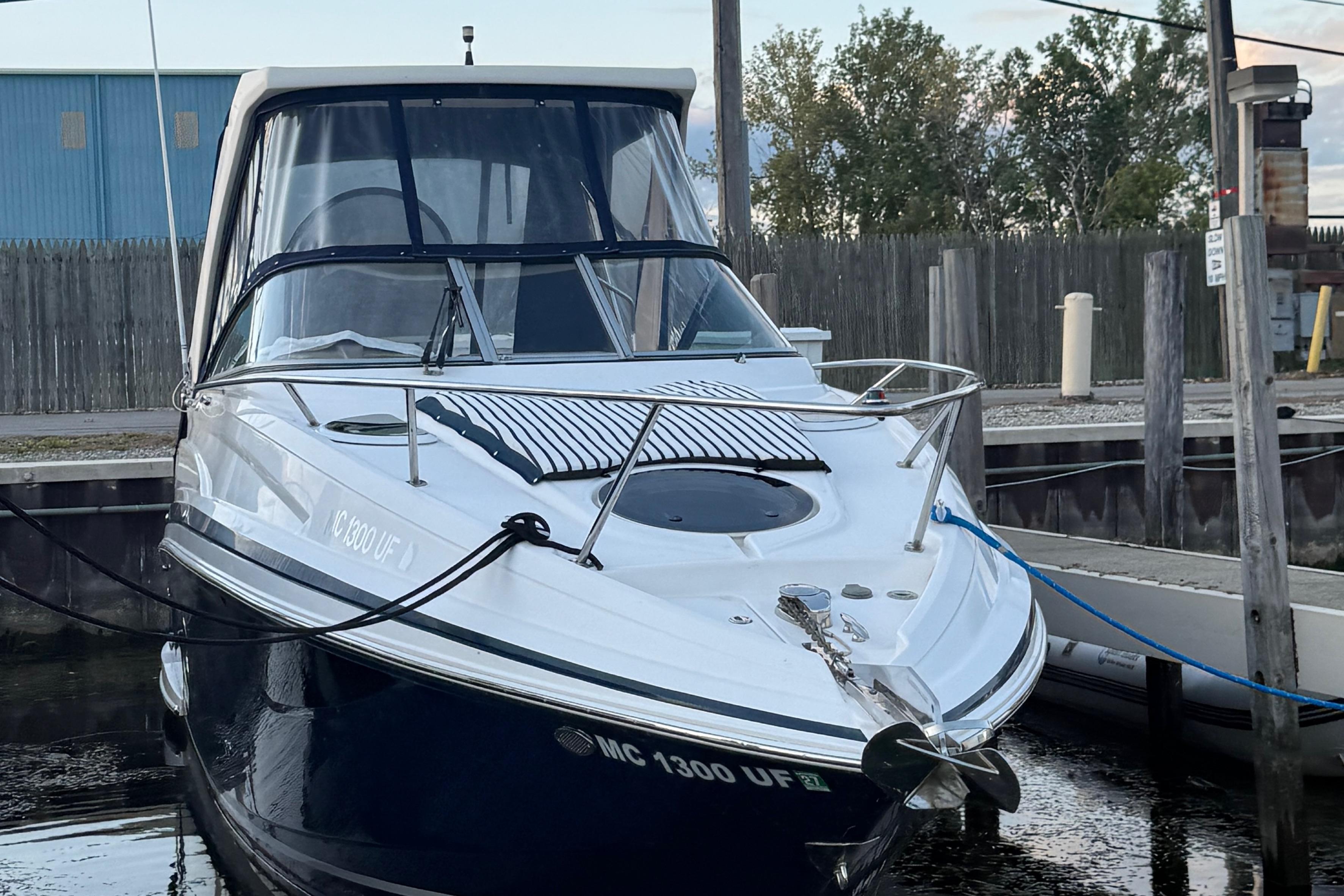 2018 Regal 28 Express boat docked at marina, front view.