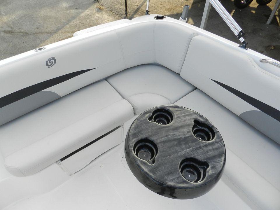 2023 Hurricane 188 boat interior with cushioned seating and a round table.