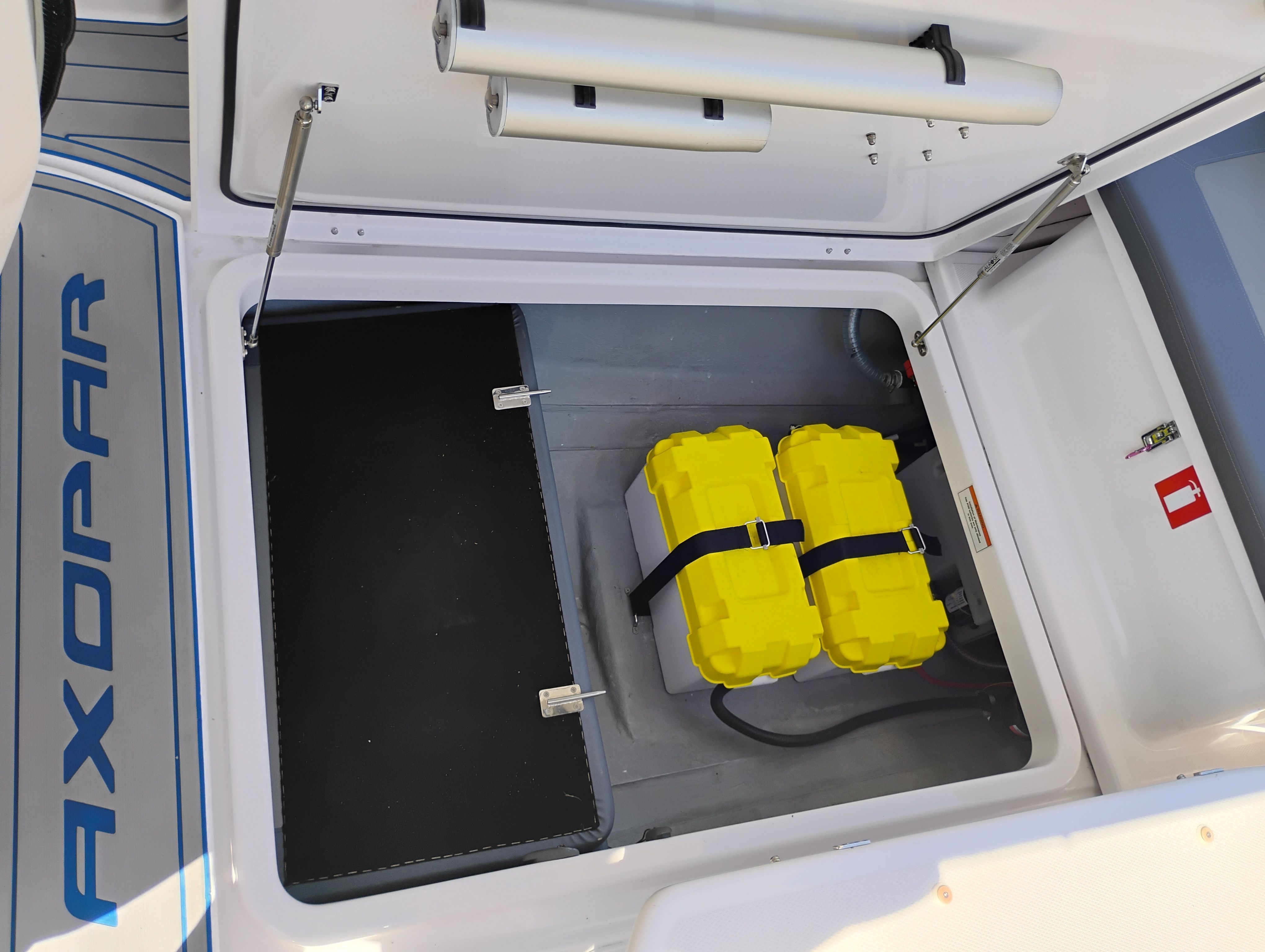 Axopar 22 T-Top 2022 boat battery compartment with yellow batteries.