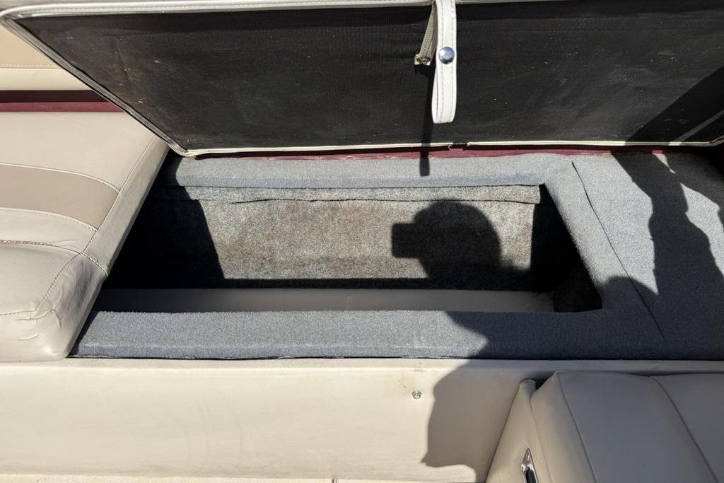 Open storage compartment in a 1999 Glastron GT 225 boat interior.