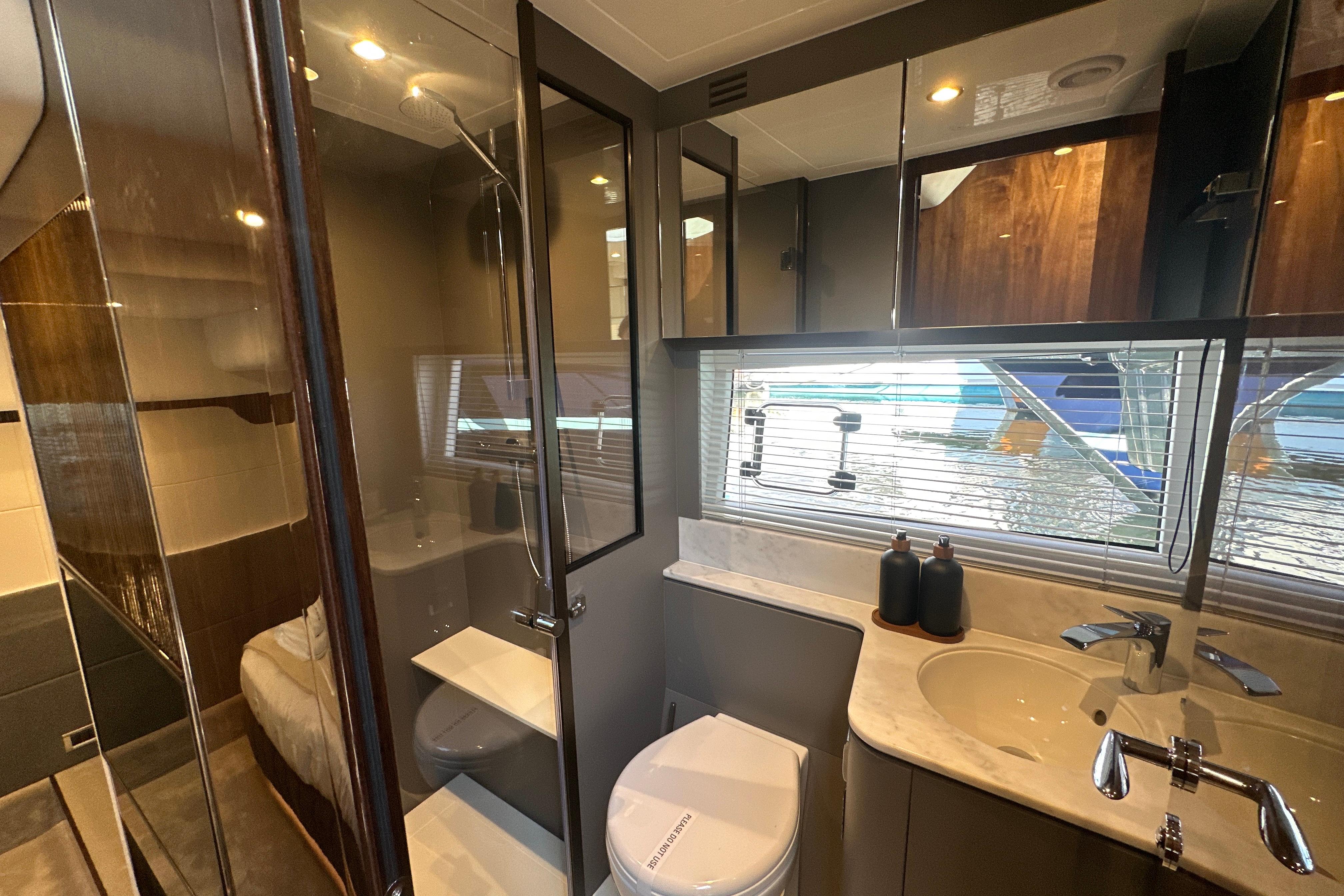 Luxurious bathroom interior of 2026 Fairline Targa 47 GT yacht, featuring modern fixtures and elegant design.