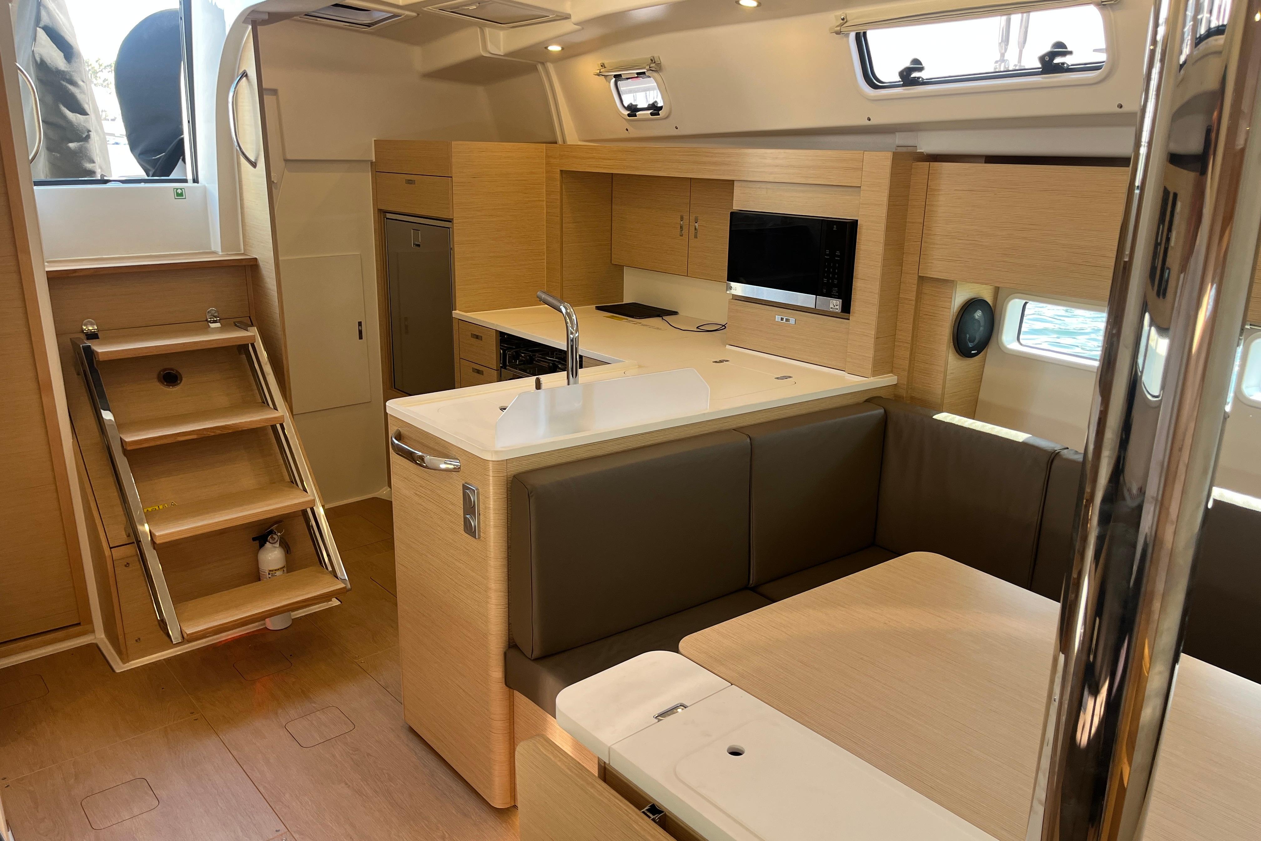 Modern interior of 2025 Hanse 360 yacht with kitchen and seating area.