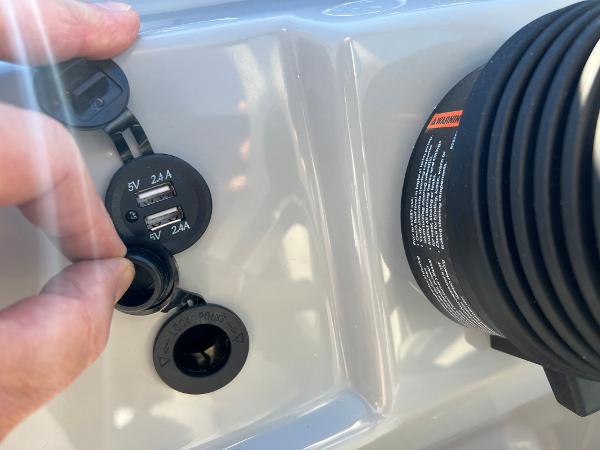 Close-up of USB ports and a charger on a boat.