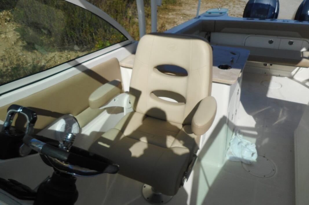 Interior of 2020 Sailfish 275 DC boat featuring a beige captain's chair and steering wheel.