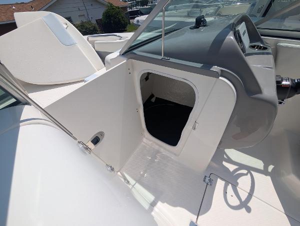 2025 Robalo R207 Dual Console boat interior with open storage compartment.