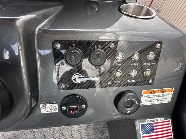 Control panel of 2024 Massimo Marine P-21R boat with various switches and ports.