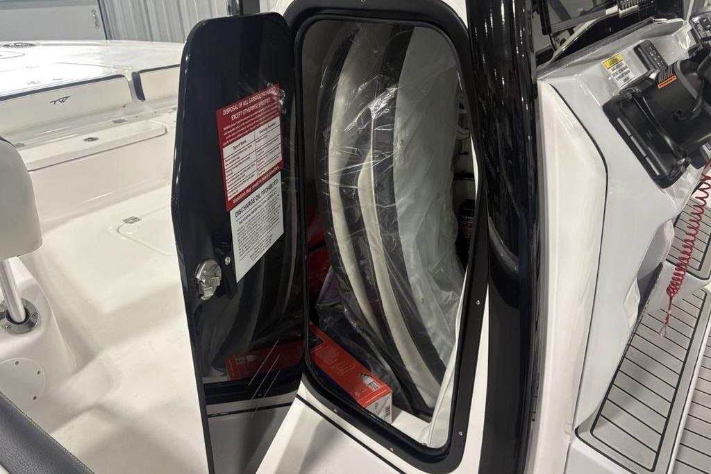 Open storage compartment on 2026 Tidewater 2300 Carolina Bay boat.