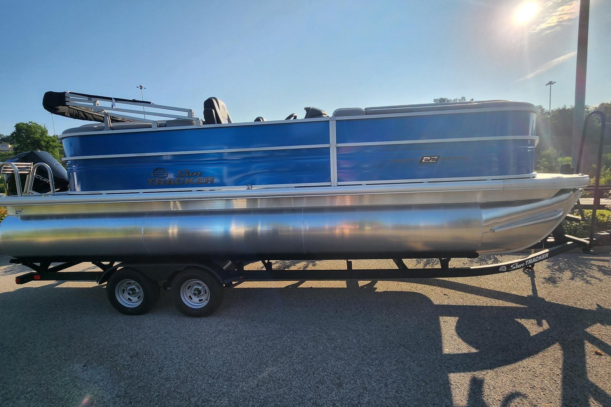 2026 Sun Tracker Party Barge 22 XP3 pontoon boat on trailer in sunlight.