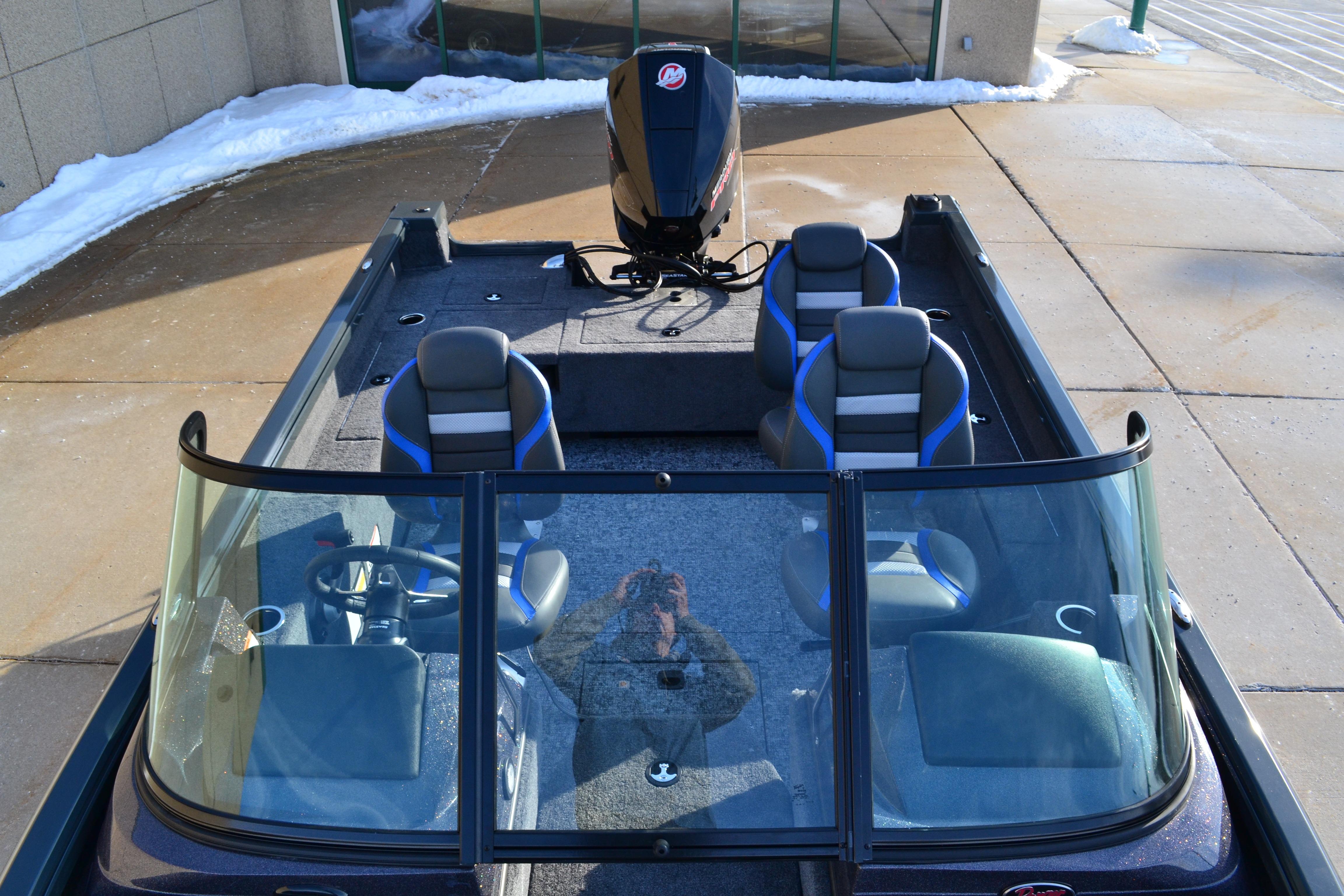 2026 Ranger VS1882SC Reata boat with four seats and windshield, parked on snowy pavement.