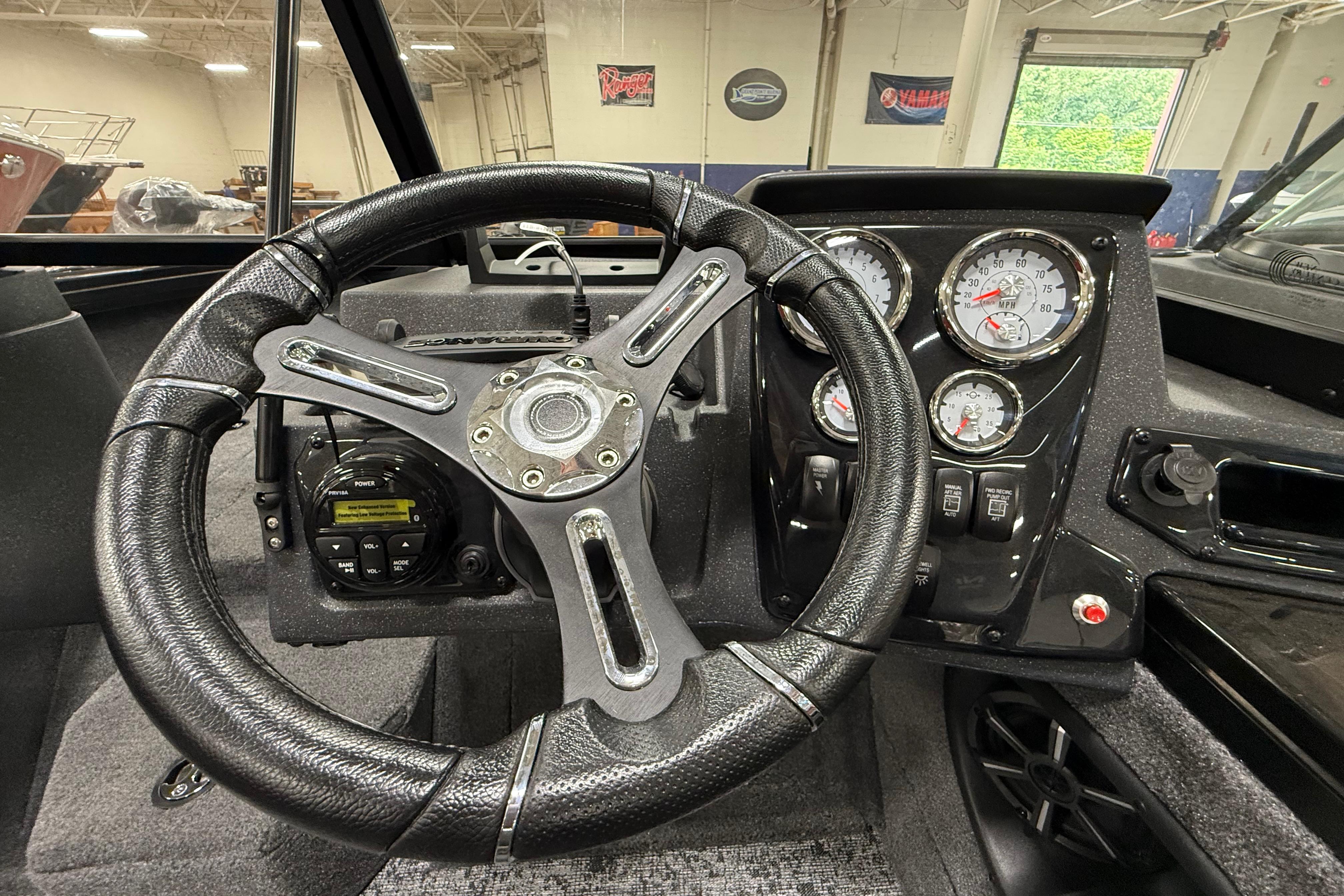 Steering wheel and dashboard of 2026 Tracker Targa V-19 WT boat, featuring gauges and controls.