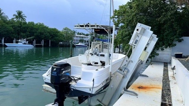 A 2004 Wellcraft 180 Fisherman boat is docked in a calm waterway.