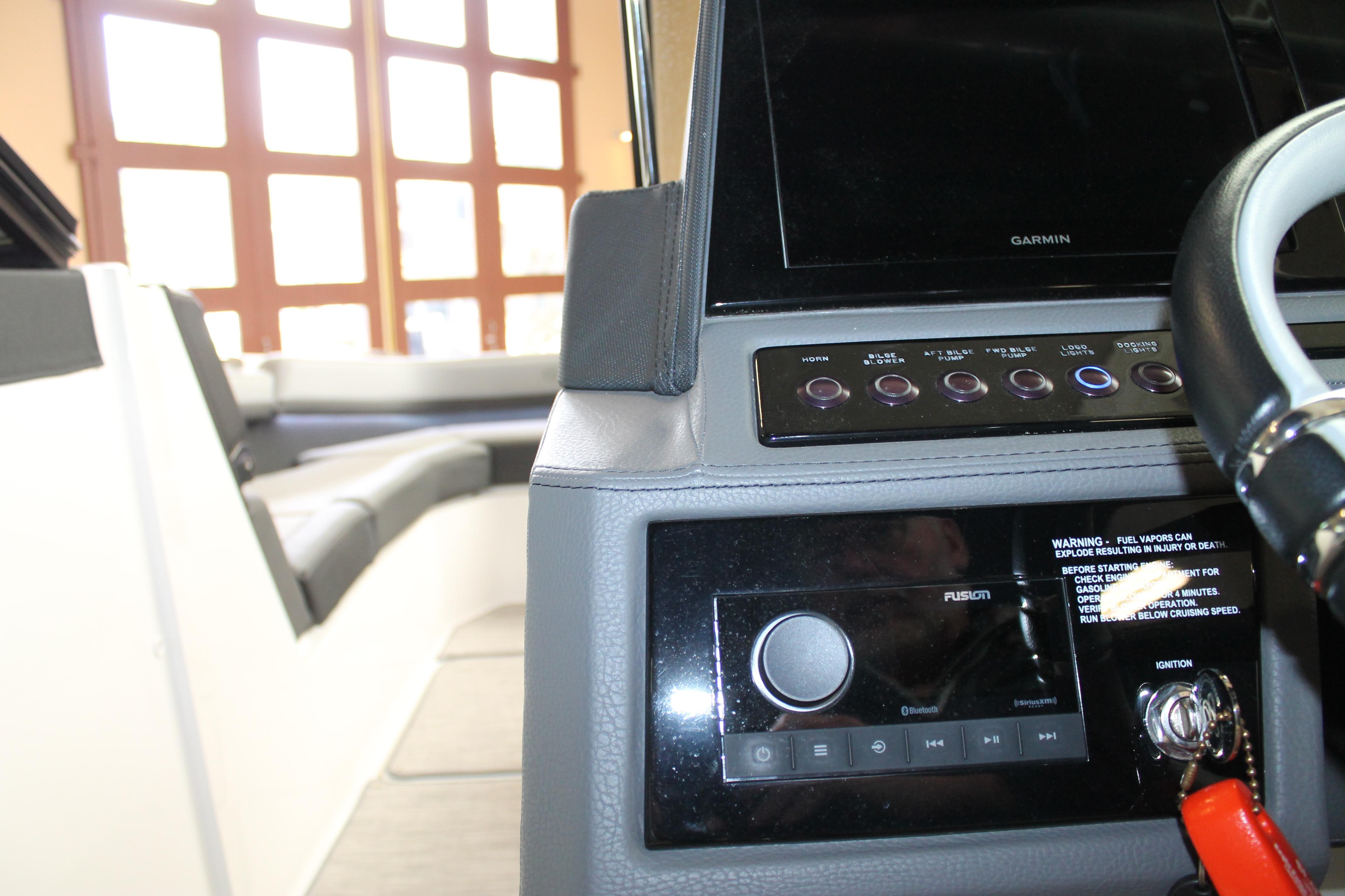 Interior view of a 2023 Cobalt R8 boat dashboard with steering wheel and controls.