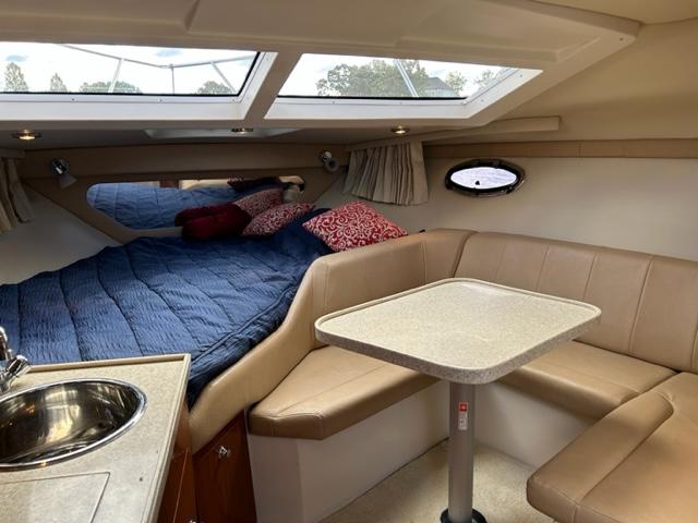 Interior of 2010 Regal 3060 Window Express boat with bed, seating, and table.