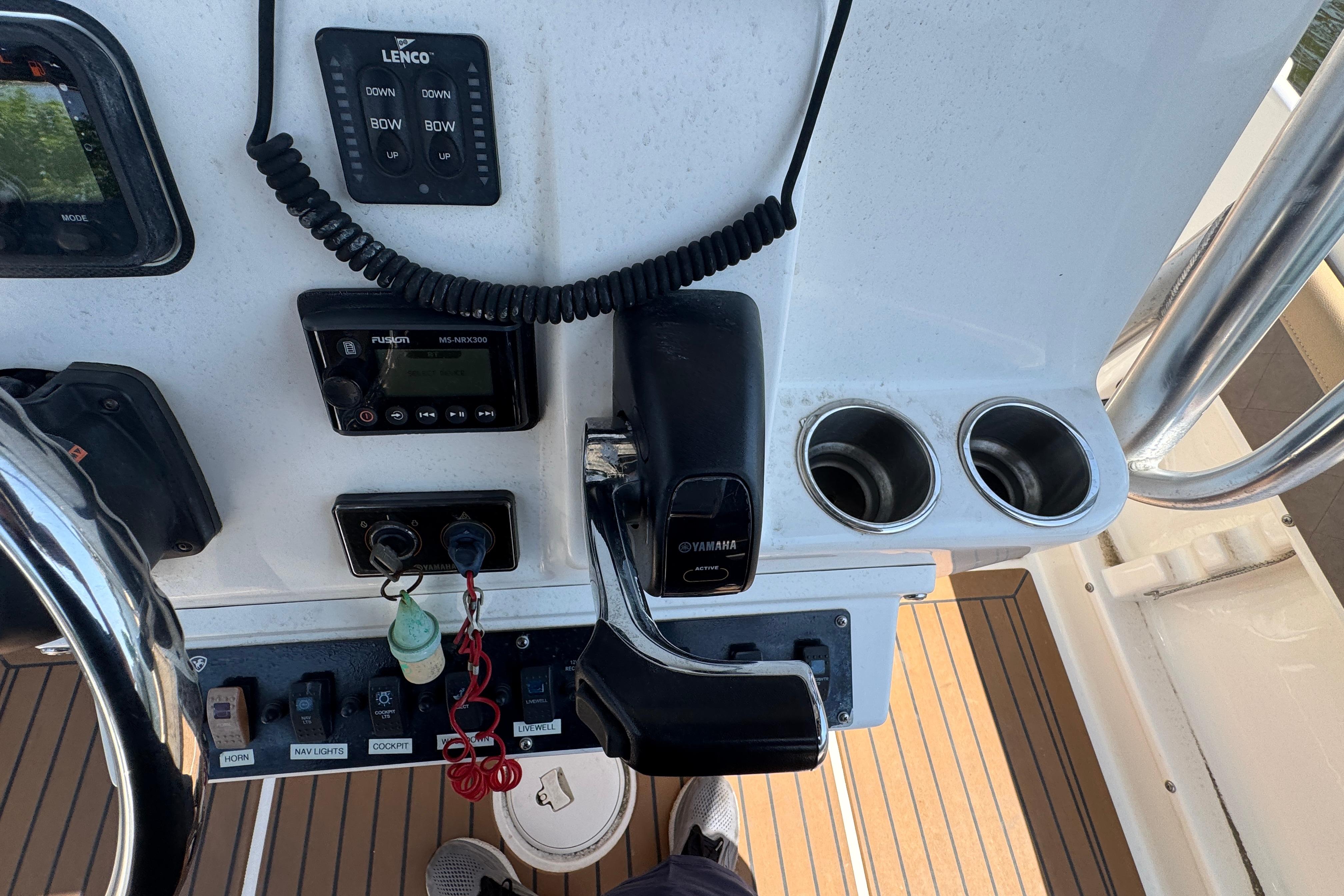 Control panel of a 2014 Century 2301 Center Console boat with steering and cup holders.