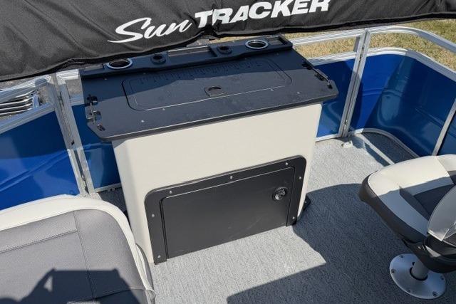 2026 Sun Tracker Fishin' Barge 20 DLX interior with seating and storage.