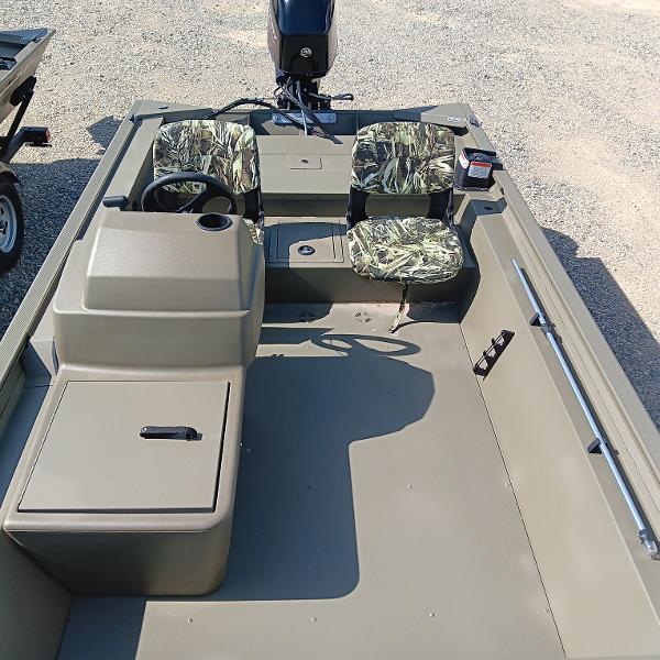 2025 Tracker Grizzly 1754 SC boat interior with camouflage seats and steering console.