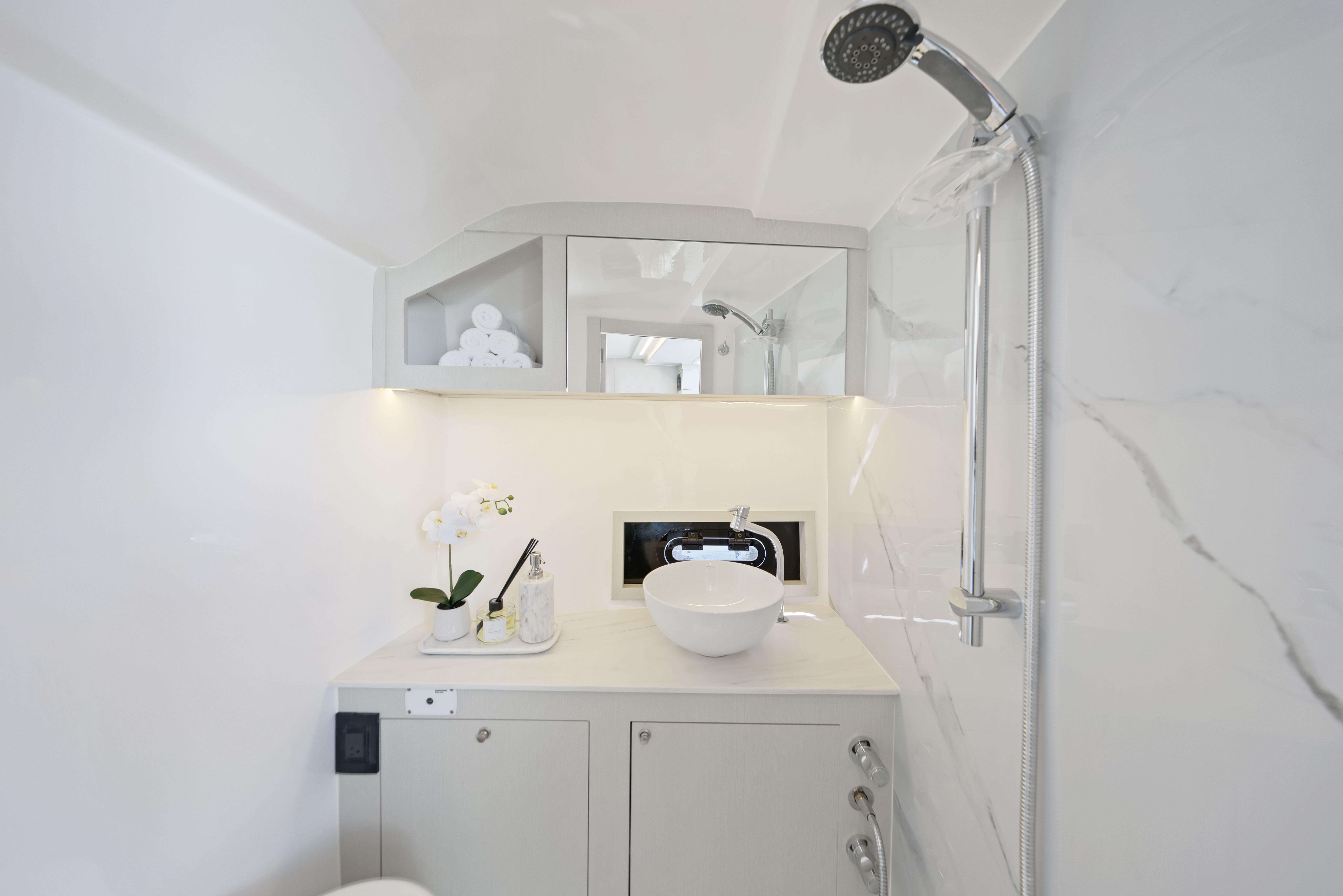 Luxurious bathroom in 2025 Valiatt 380 Bowrider boat with modern fixtures and elegant design.