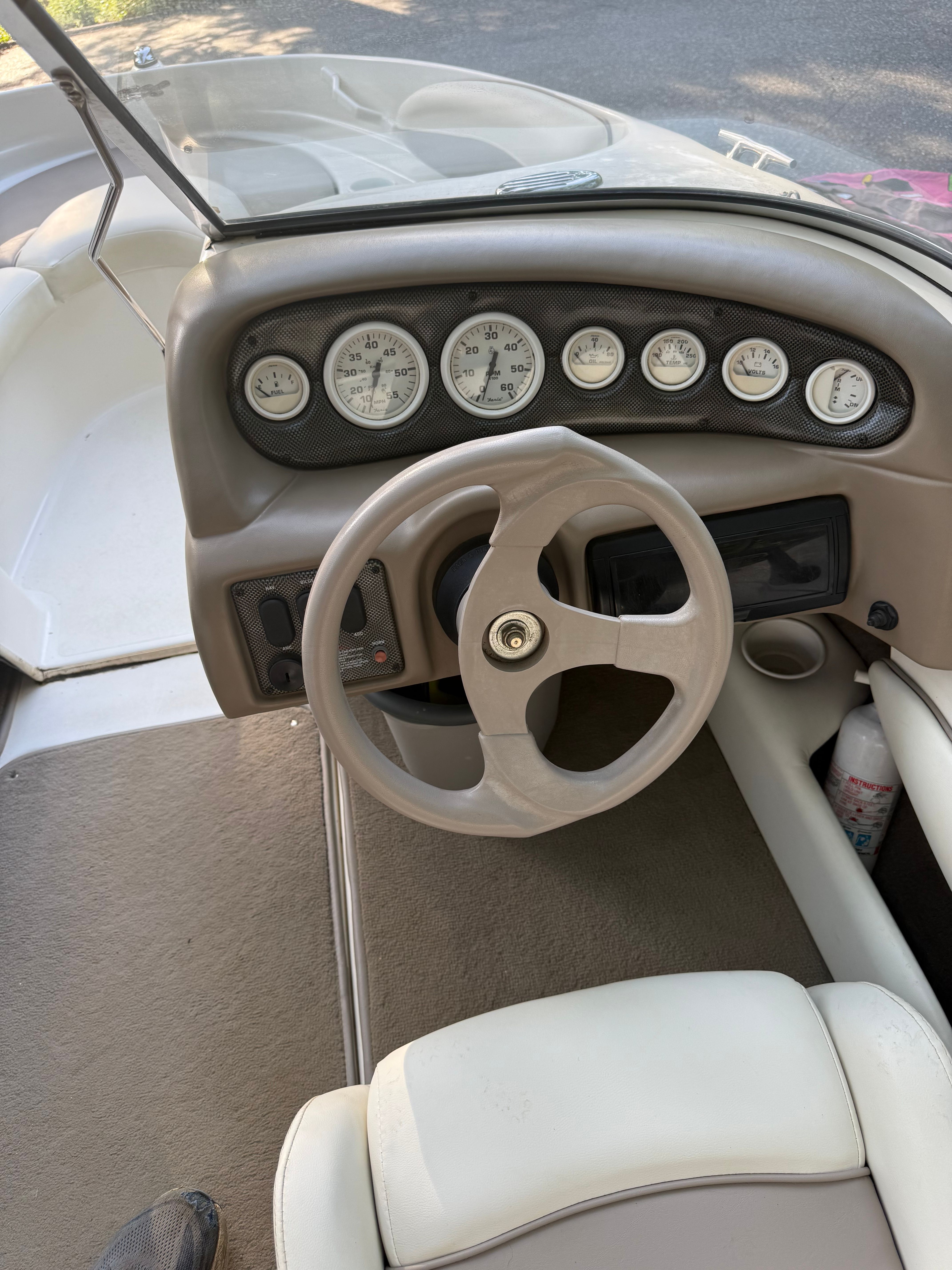 Interior view of 2003 Glastron SX 195 boat cockpit with dashboard.