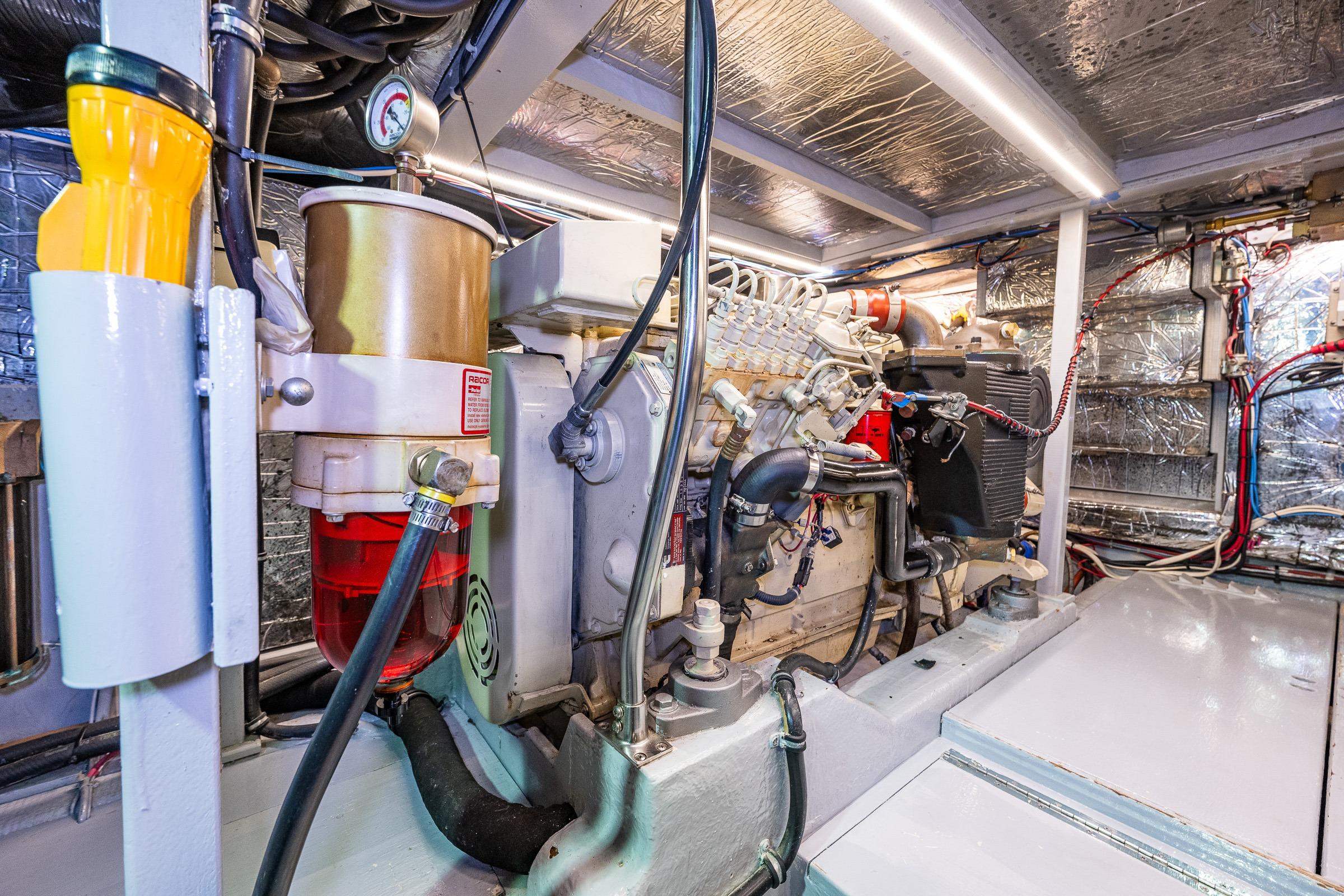 Engine room of 1991 Tollycraft 48 Cockpit Motor Yacht, showcasing detailed mechanical components.