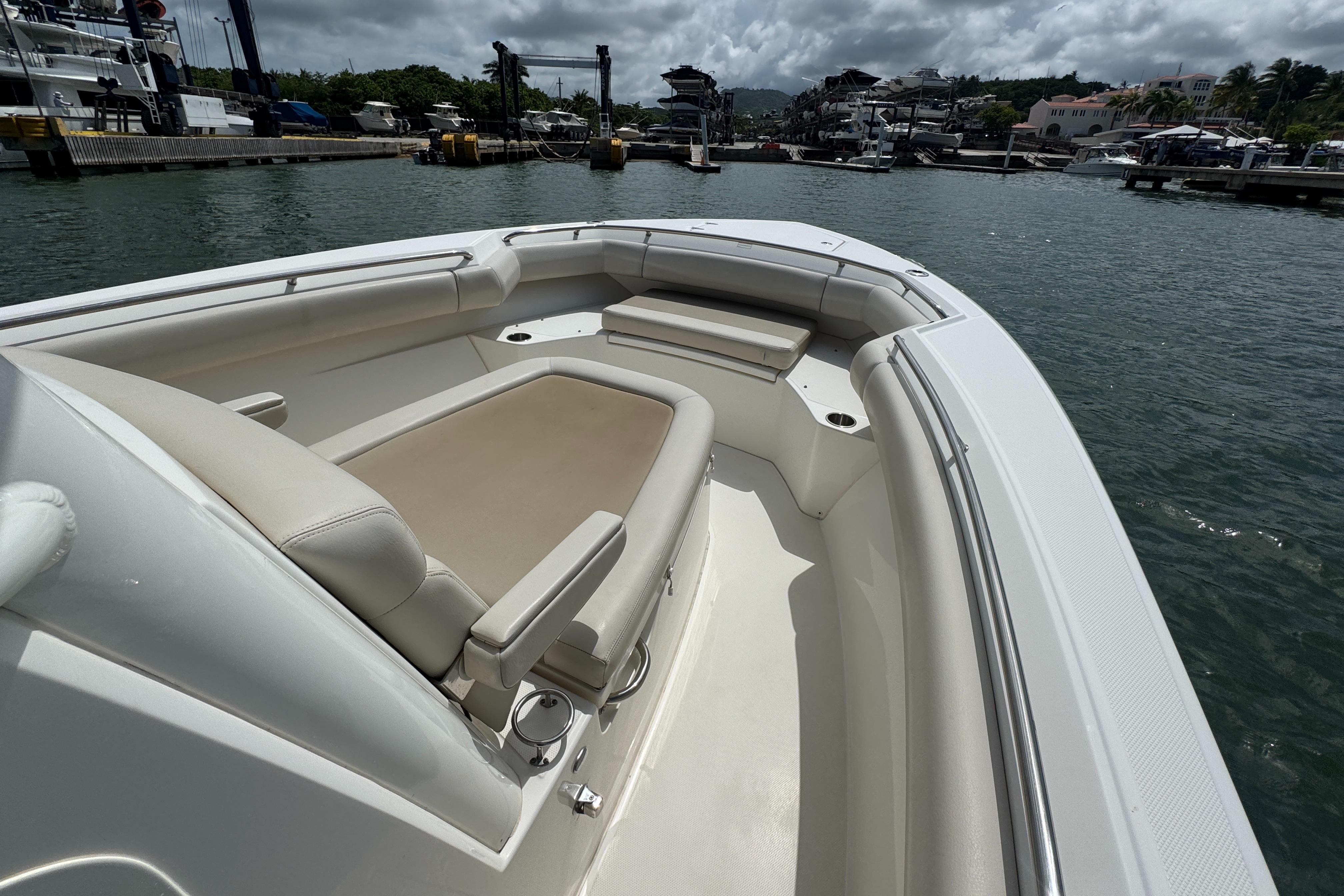 2022 Boston Whaler 280 Outrage boat with spacious seating, docked at a marina.