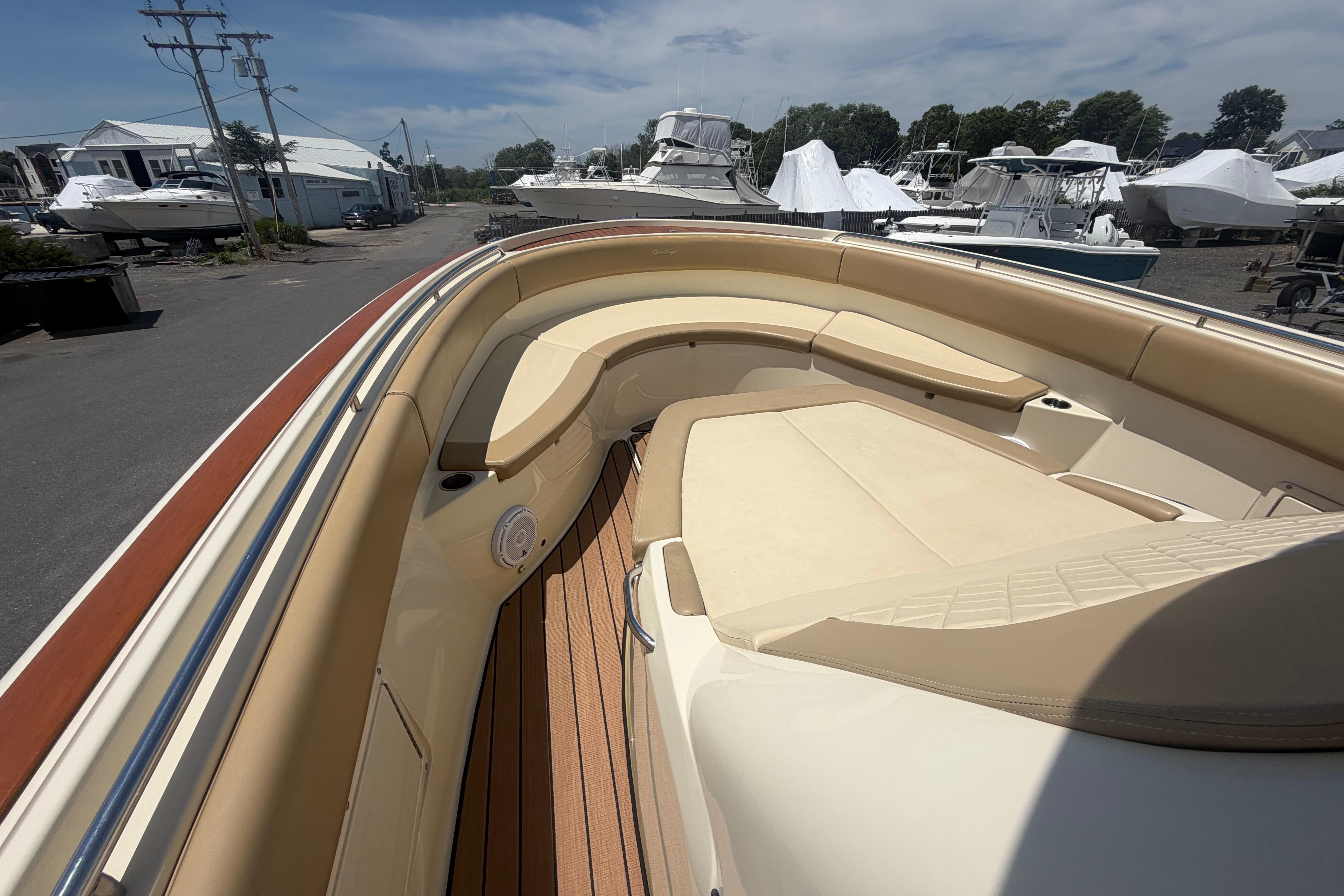2017 Chris-Craft Catalina 34 boat interior with beige seating and wooden deck.