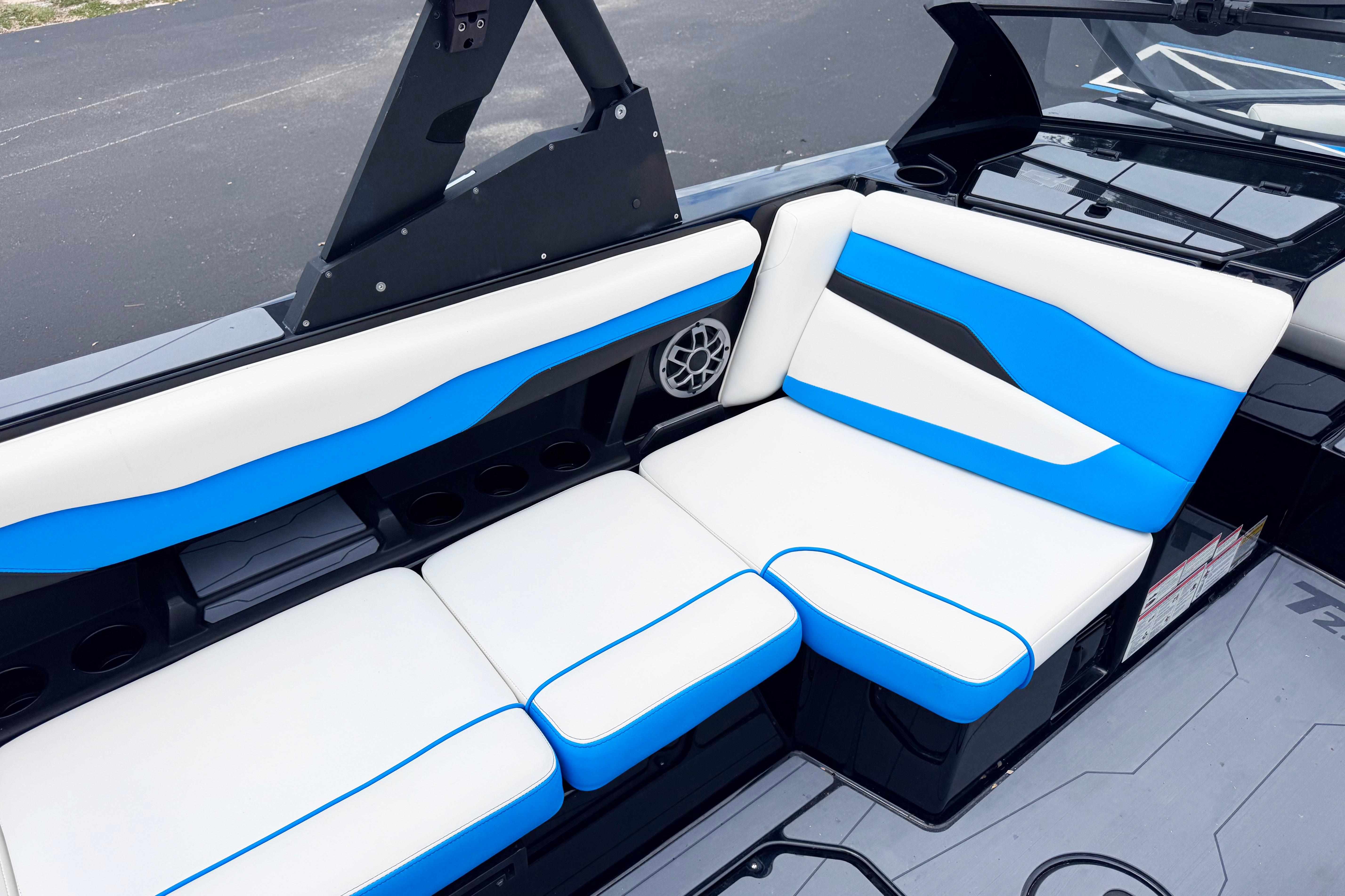 2022 Axis T220 boat interior with blue and white seating, featuring modern design and speaker system.