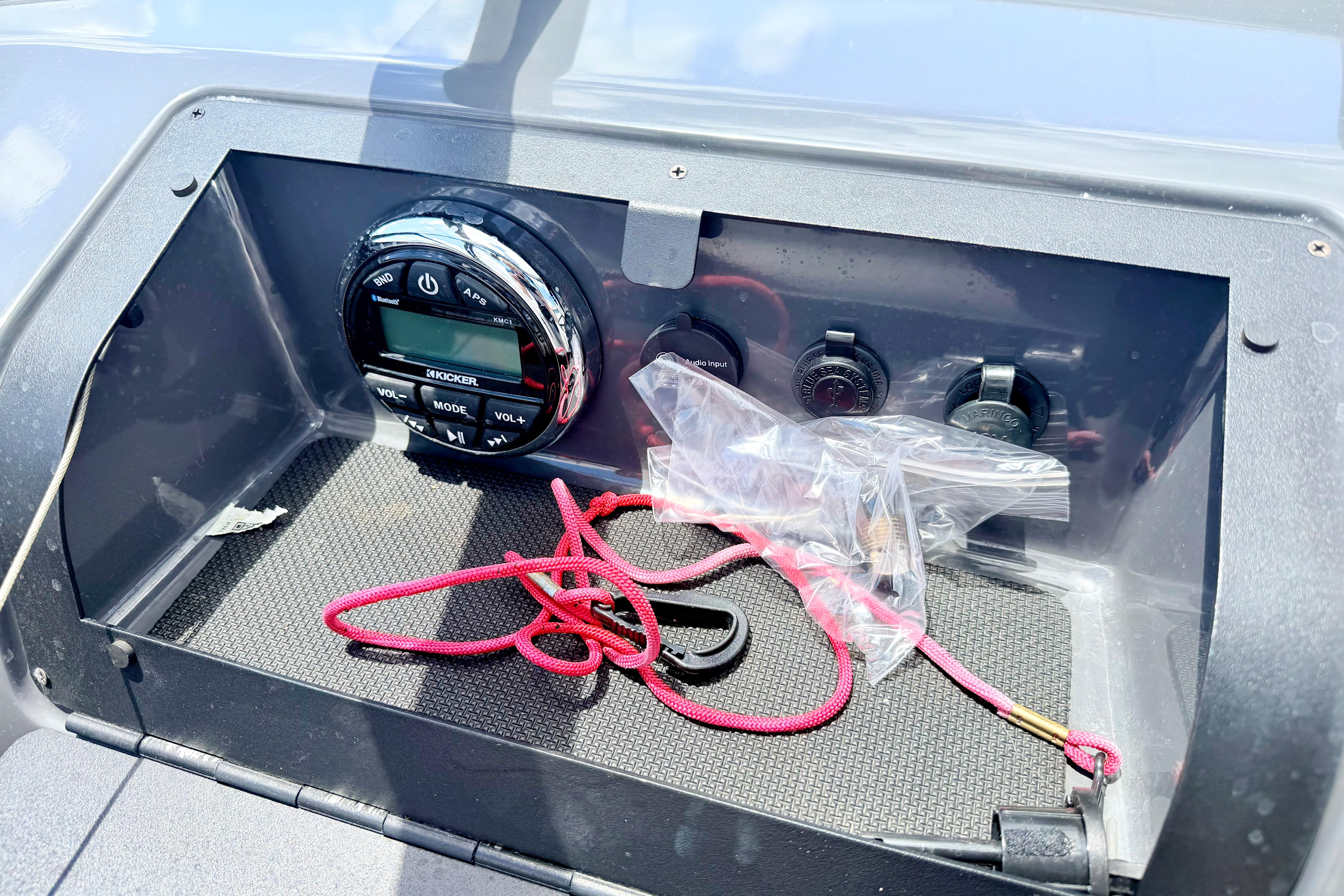 Dashboard of 2018 Glastron GT 185 boat with audio controls and red cord.