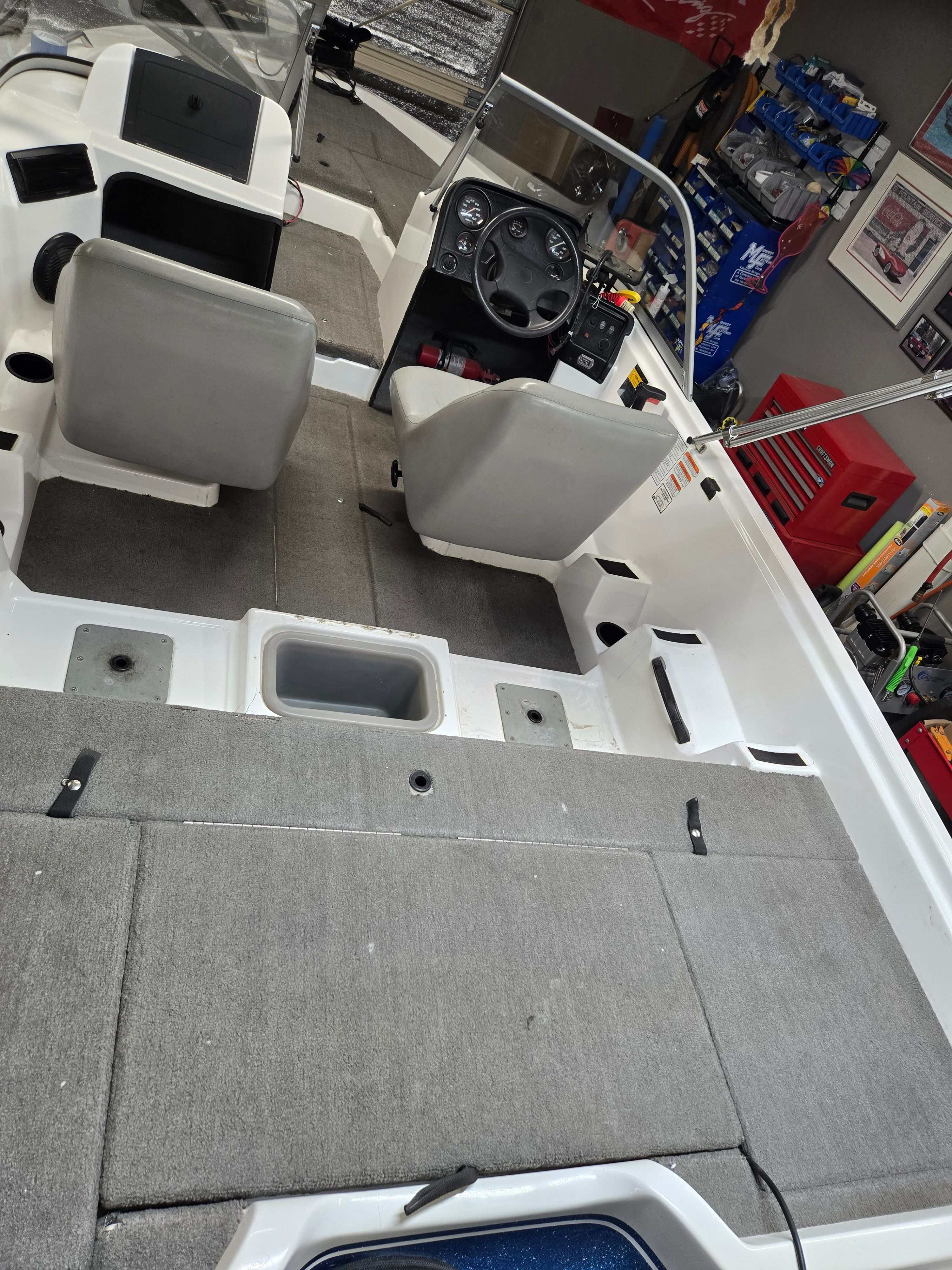 Interior view of a 2007 ProCraft 170 Combo with gray seats and a steering console.