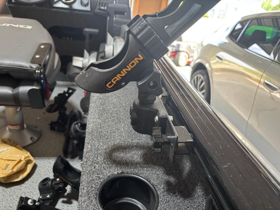 Interior view of a boat with a fishing rod holder and seat.