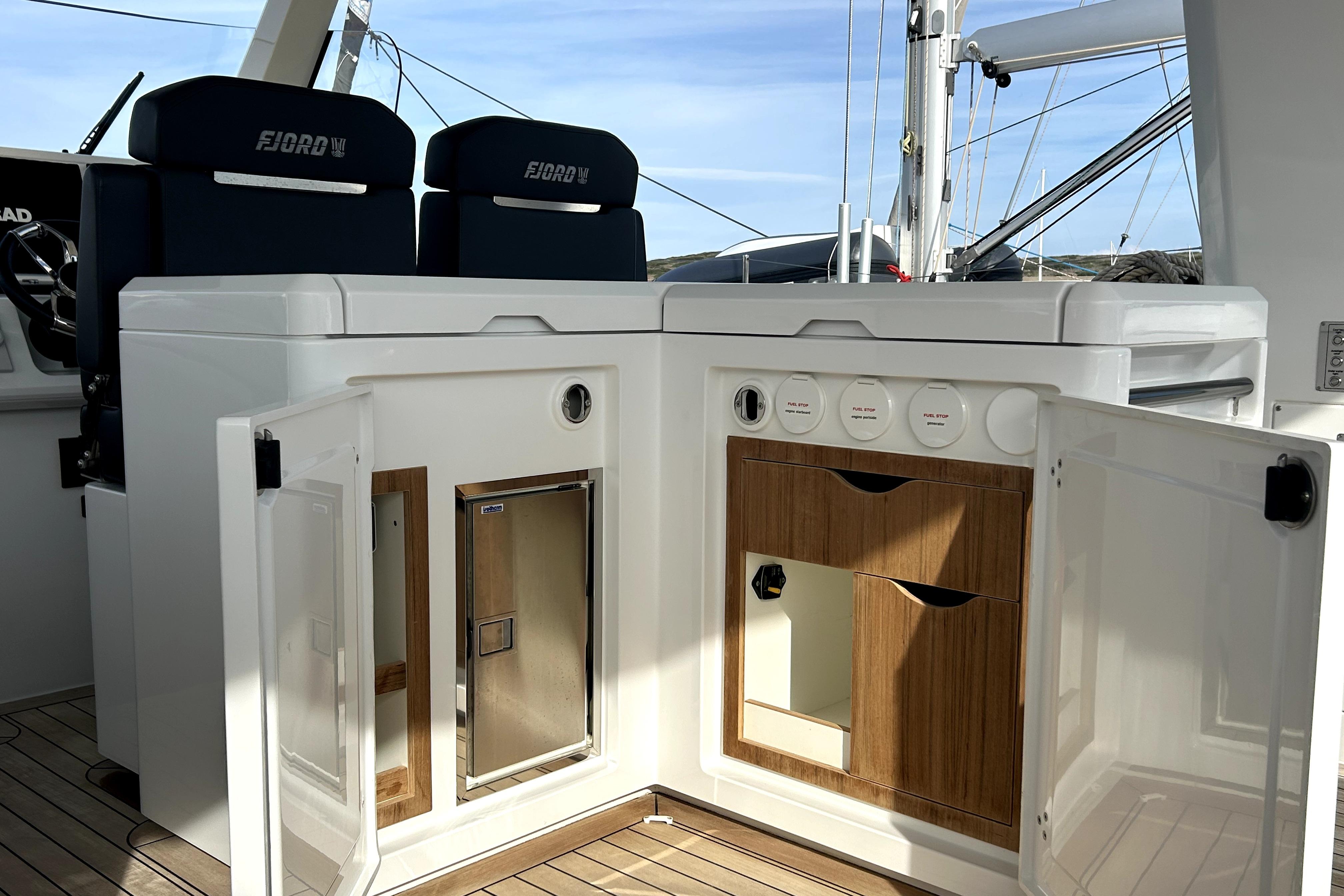 Interior of 2023 Fjord 53 XL yacht with open storage compartments and seating.