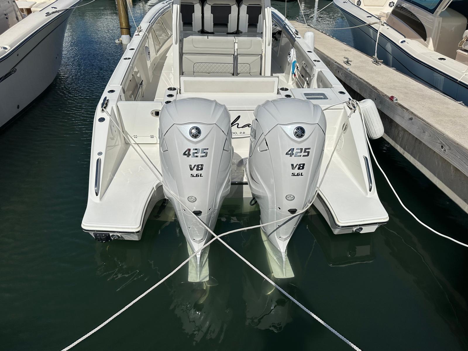 2023 Pursuit S 358 Sport boat with twin 425 V8 engines docked in marina.