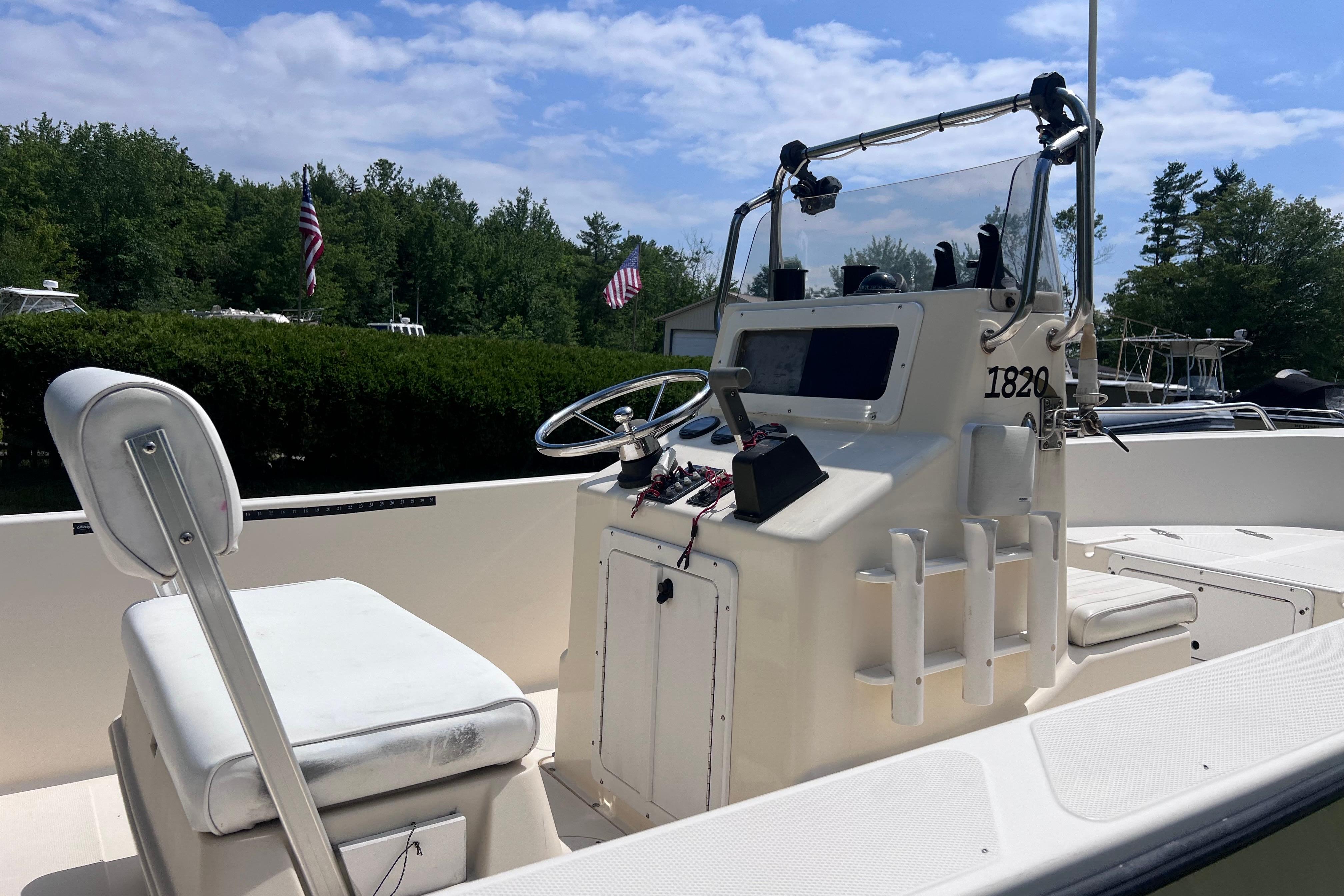 2003 May-Craft 1820CC boat interior with steering console and seating, under a clear sky.