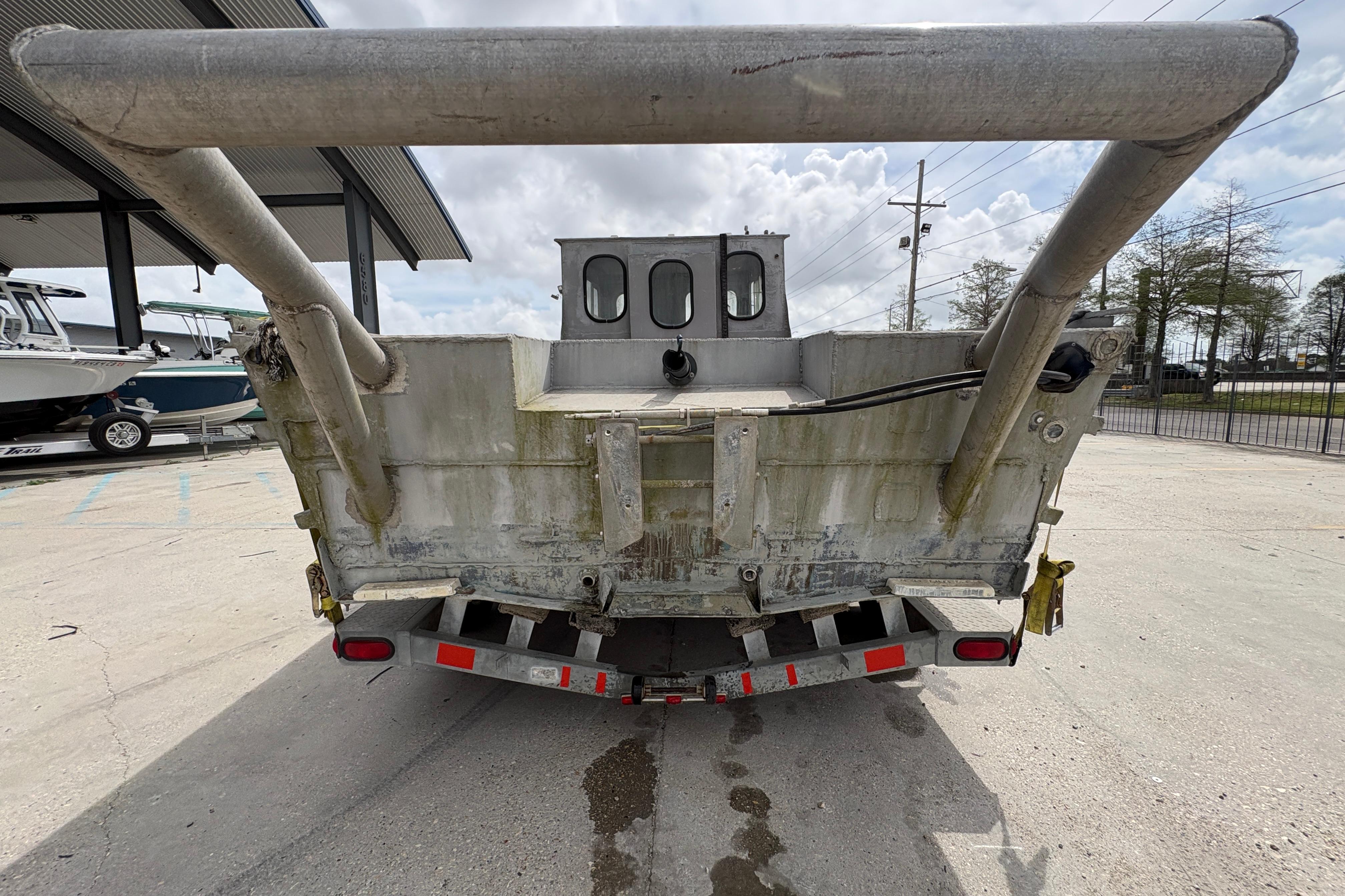 Rear view of a 1972 Custom 23' work/push boat on a trailer.