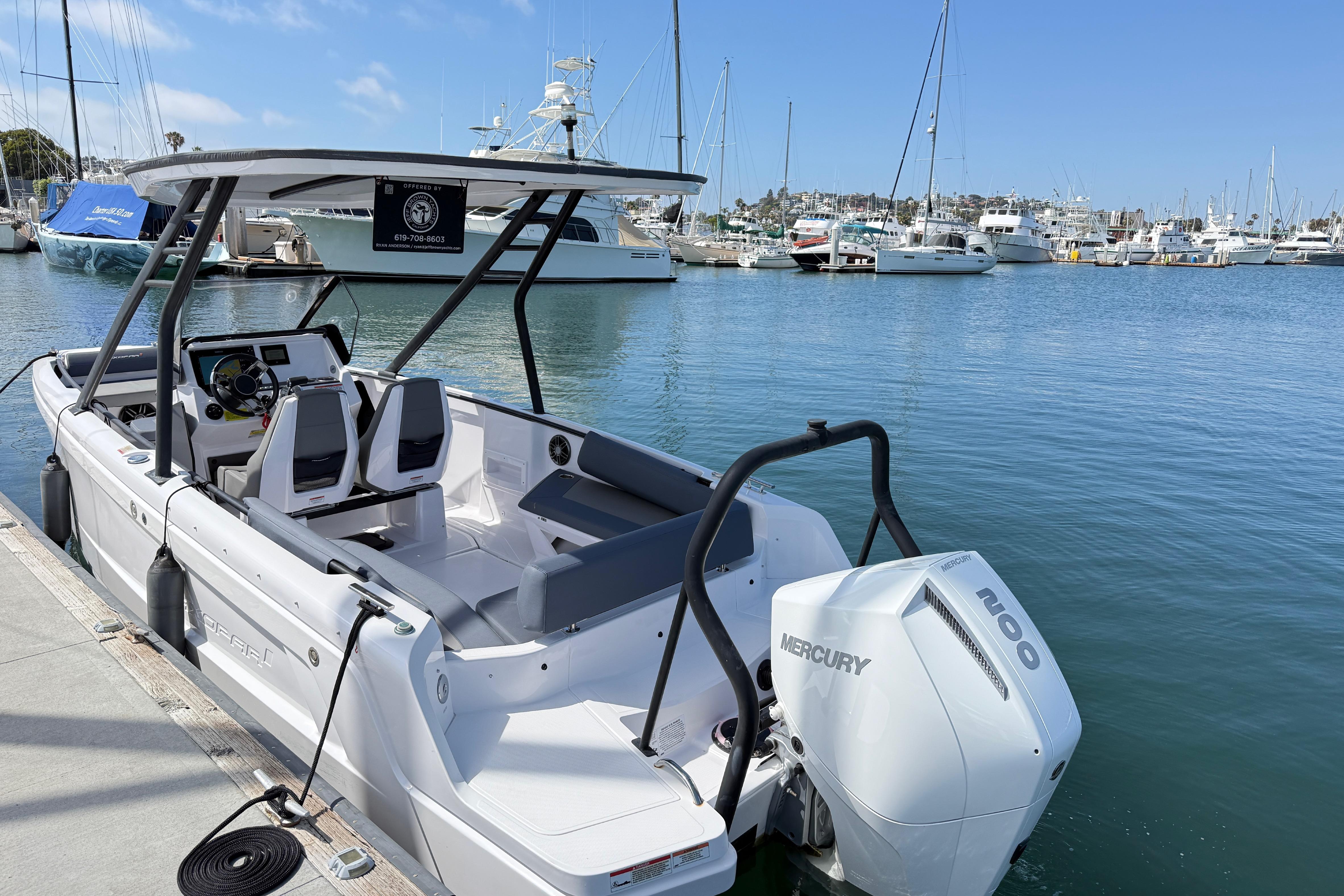 2022 Axopar 22 T-Top boat docked in a marina with Mercury engine.