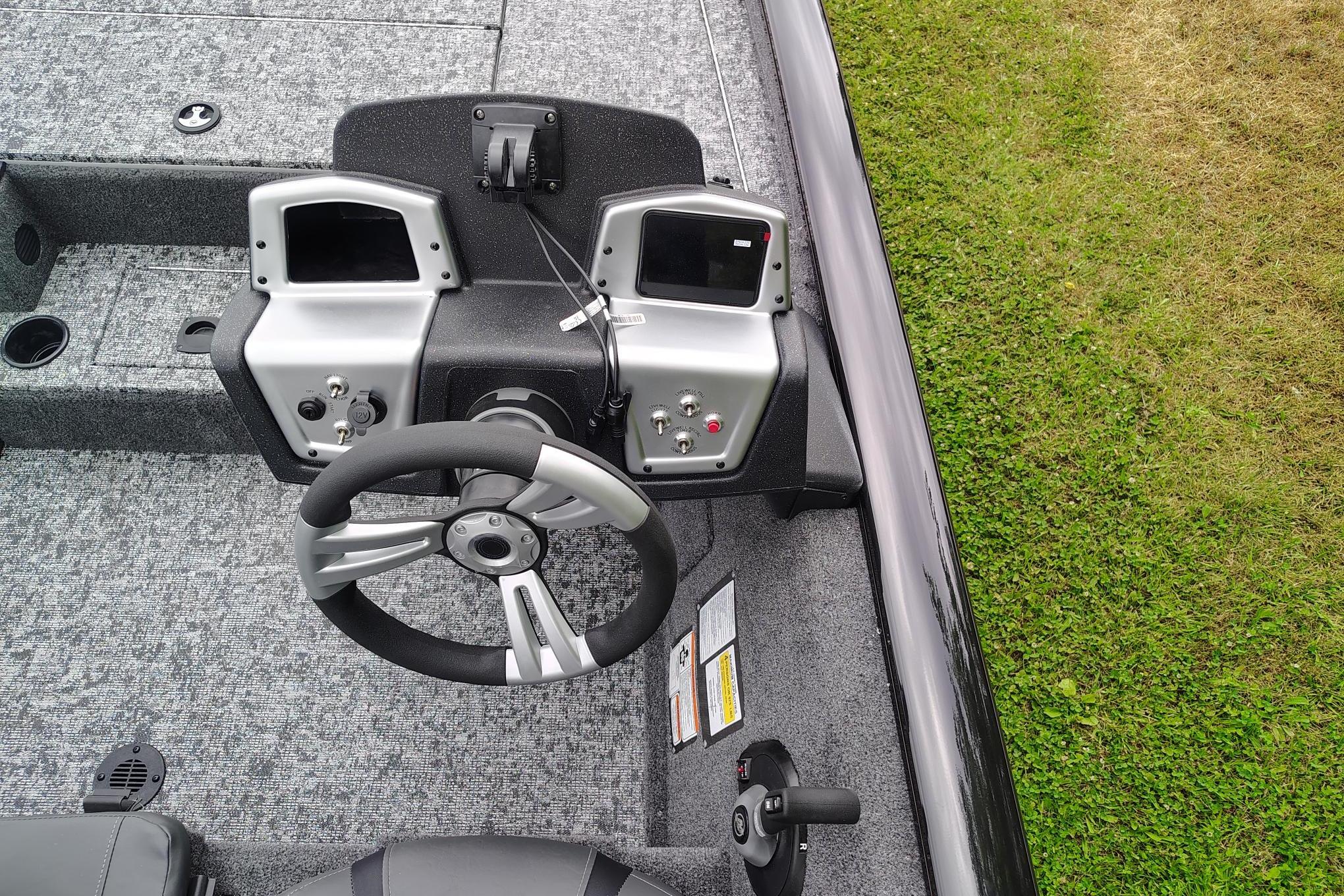 2026 Tracker Pro Team 195 boat dashboard with dual displays and steering wheel.
