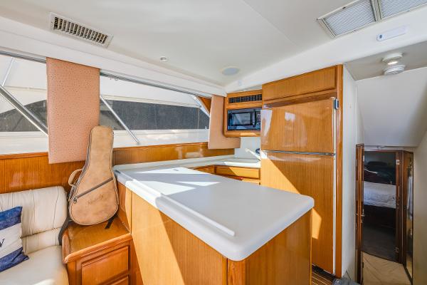 Interior of 1999 Viking 47 Convertible yacht with kitchen and guitar case.