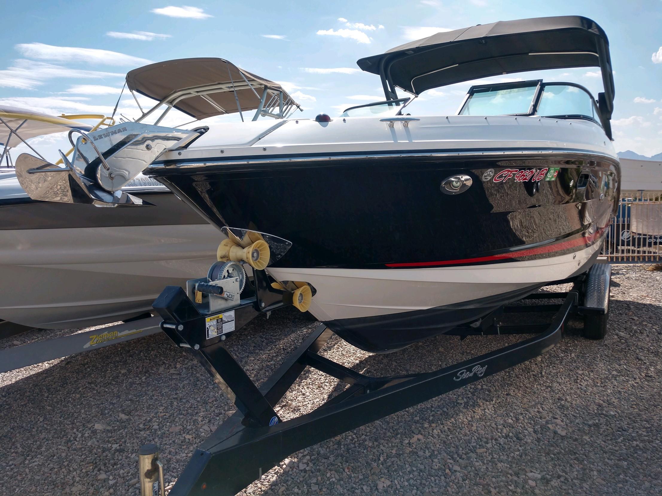 2018 Sea Ray SLX 280 boat on a trailer in a sunny outdoor setting.
