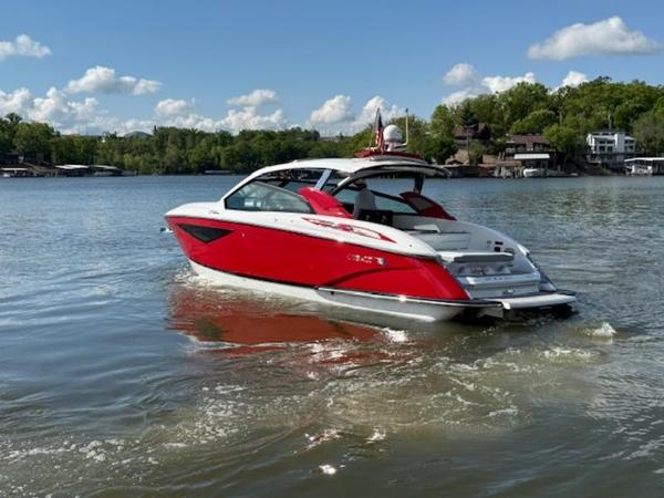 2022 Cobalt A36BR boat in vibrant red on a serene lake.