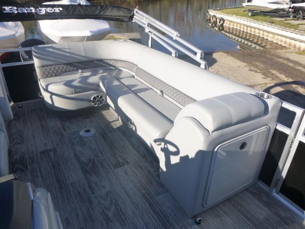 2024 Ranger Reata 223C boat interior with gray seating and wood-style flooring.