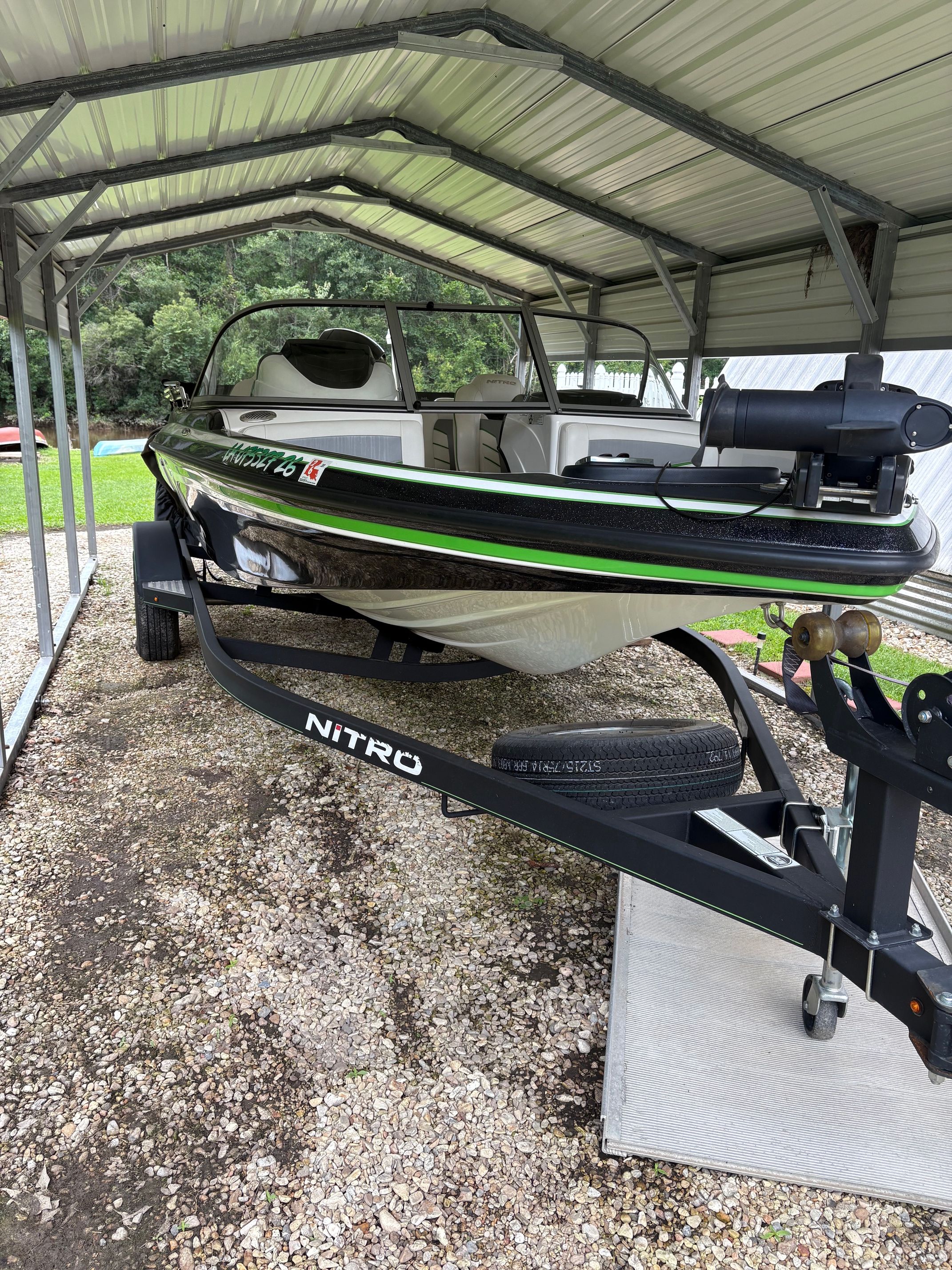 A 2021 Nitro Z19 Sport boat on a trailer under a metal shelter.