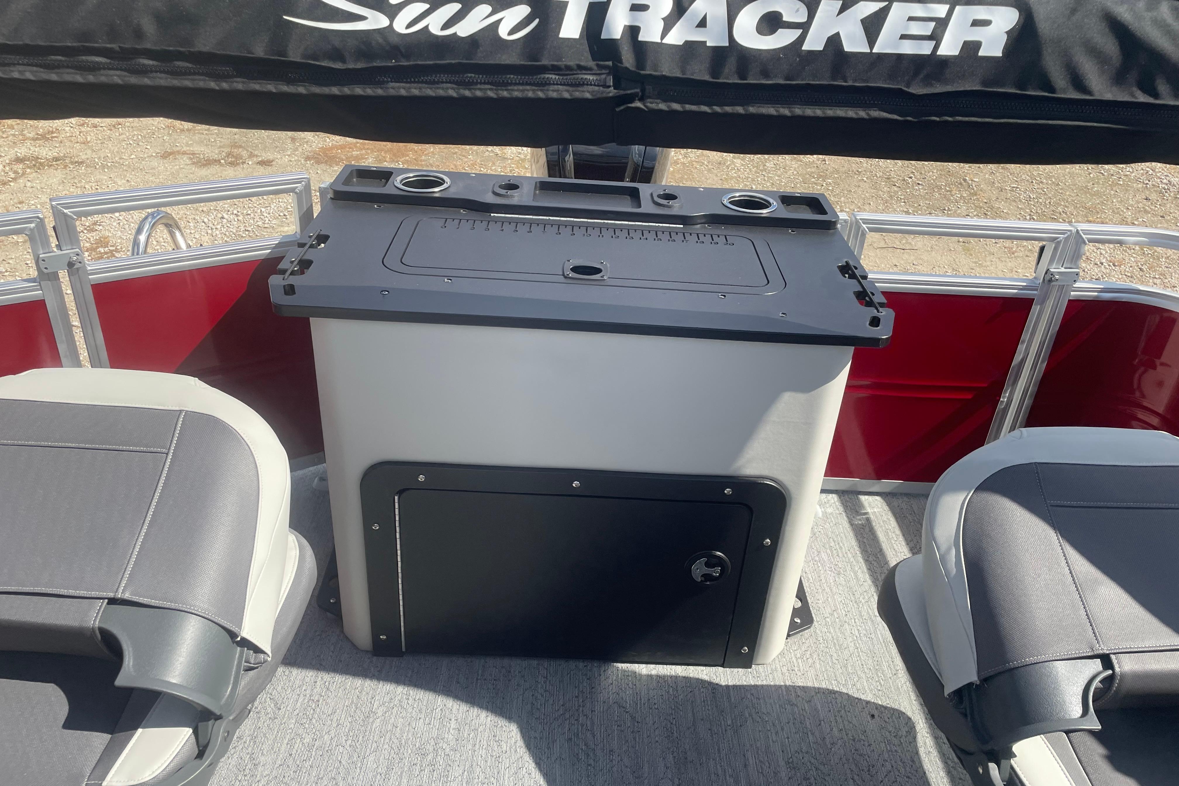 2026 Sun Tracker Fishin' Barge 22 DLX interior with seating and storage console.