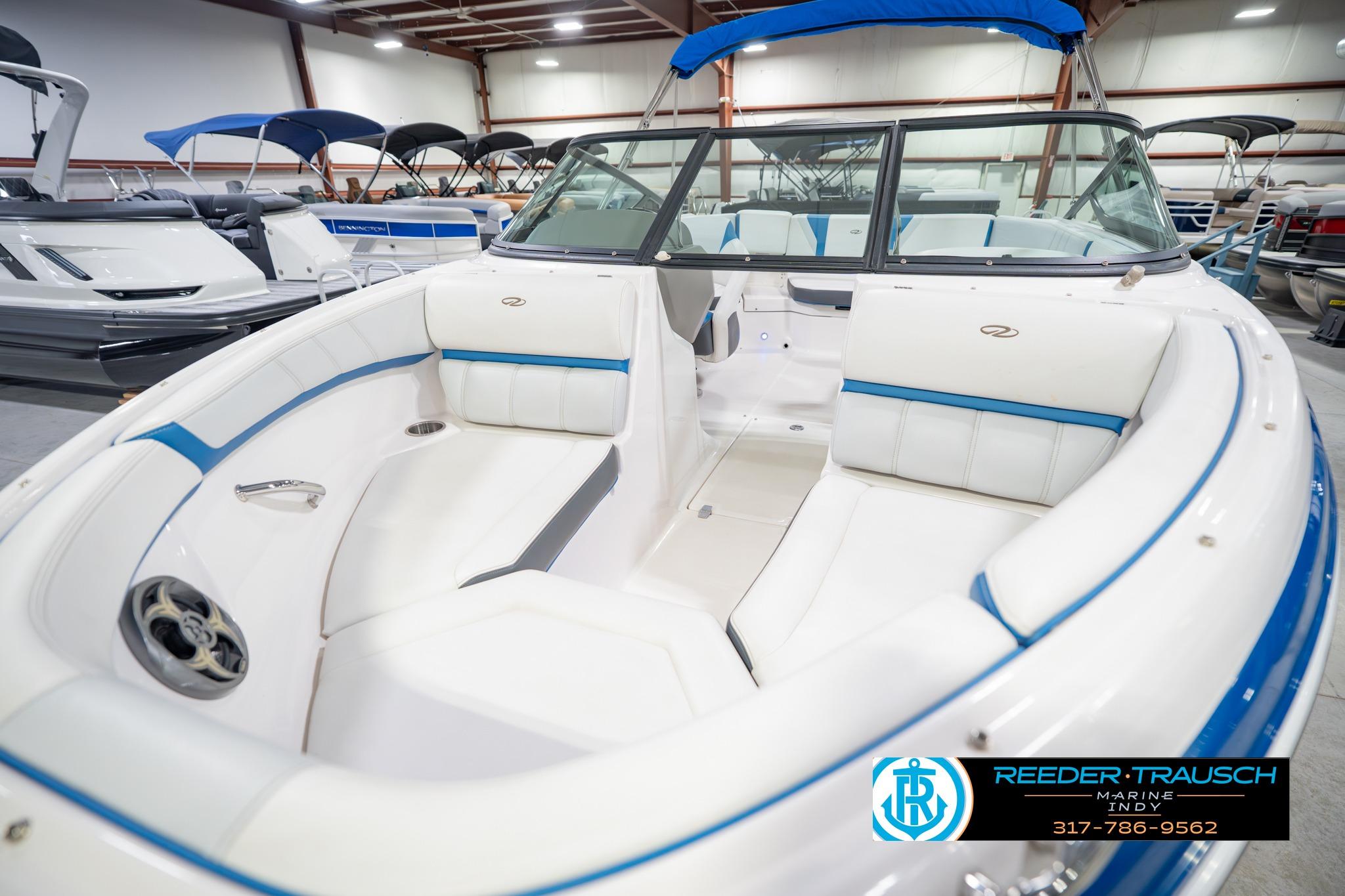 2015 Regal 2000 ESX Bowrider with white and blue interior in showroom.