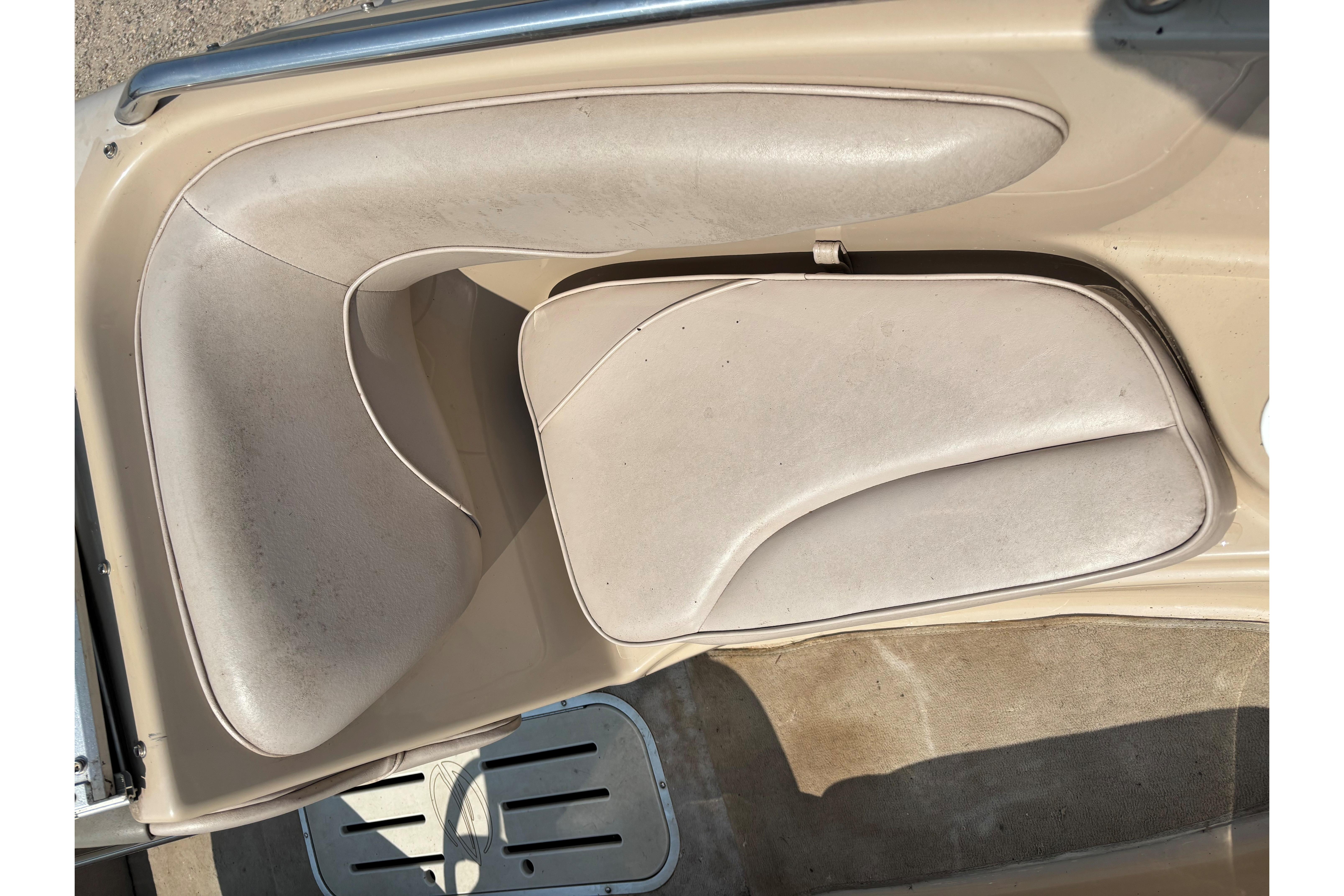 2001 Crownline 18' boat interior with beige seating and carpeted flooring.