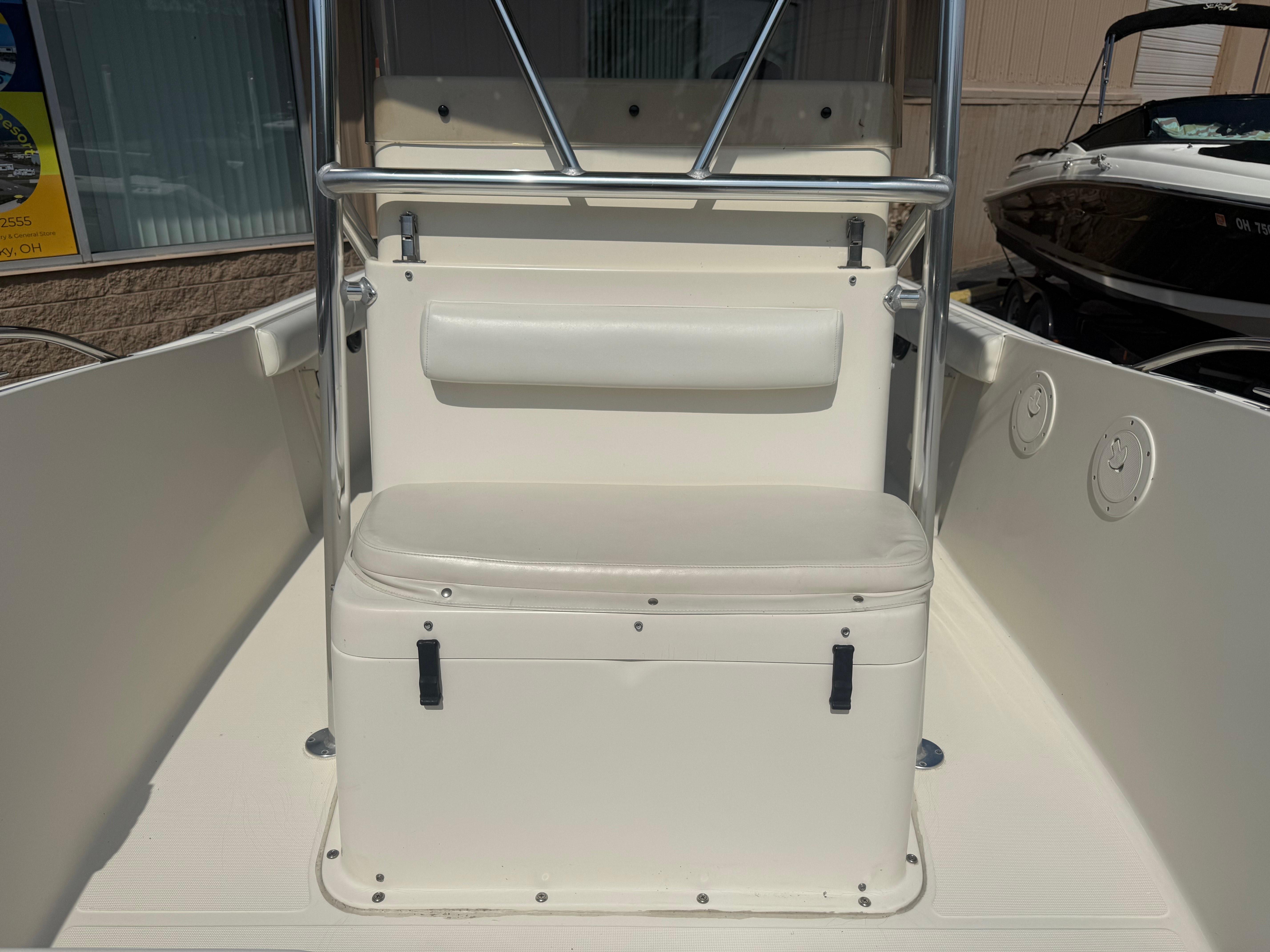 2002 Pursuit 2470 CC boat interior with white seating and storage.