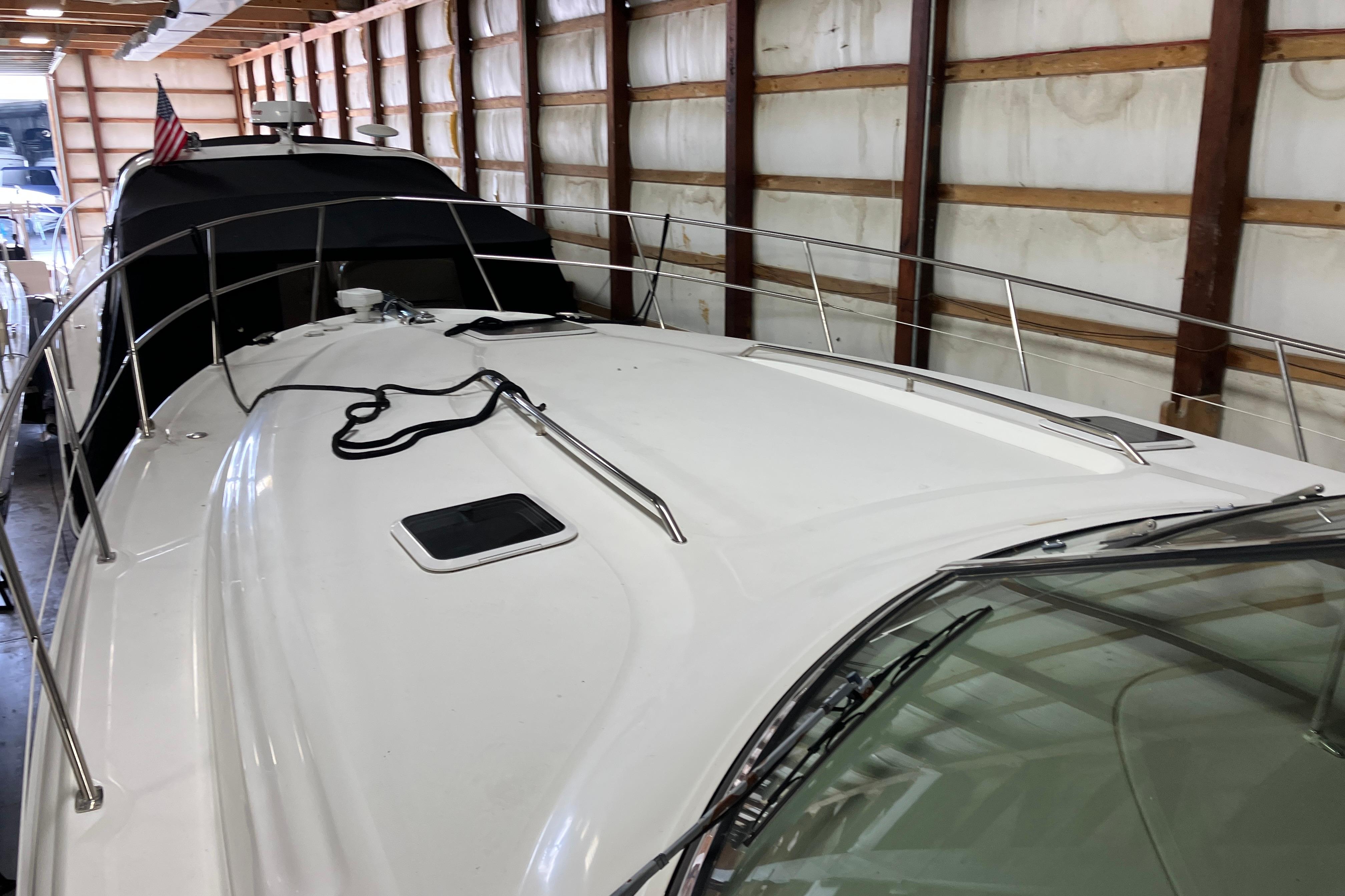 2002 Sea Ray 410 Sundancer yacht in storage, showcasing sleek deck design.